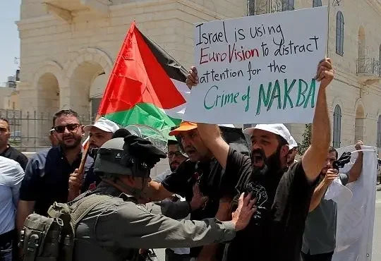 Israeli Zionists vs. Palestinian Villagers: soldier confronts protesters with Palestinian flag and Nakba sign