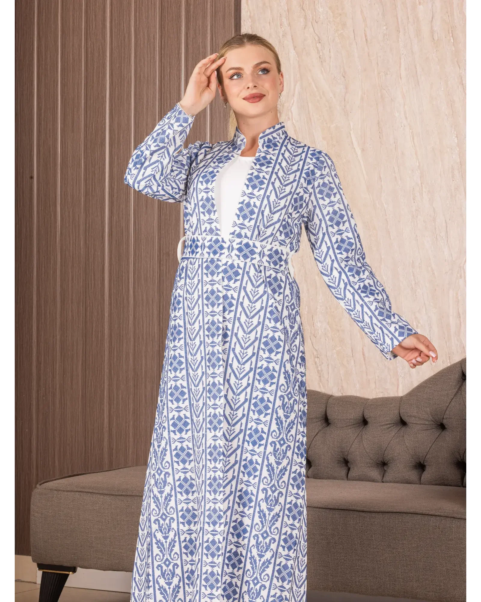 Palestinian Elegance embroidered long cardigan featuring intricate blue and white floral patterns on a full-length design