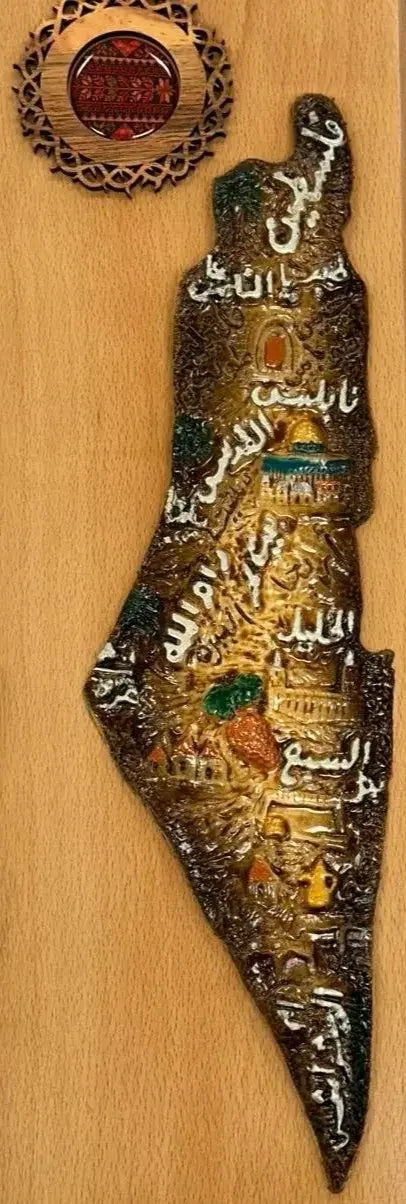 Handmade Palestine map wall art with intricate details and Arabic calligraphy on wooden background
