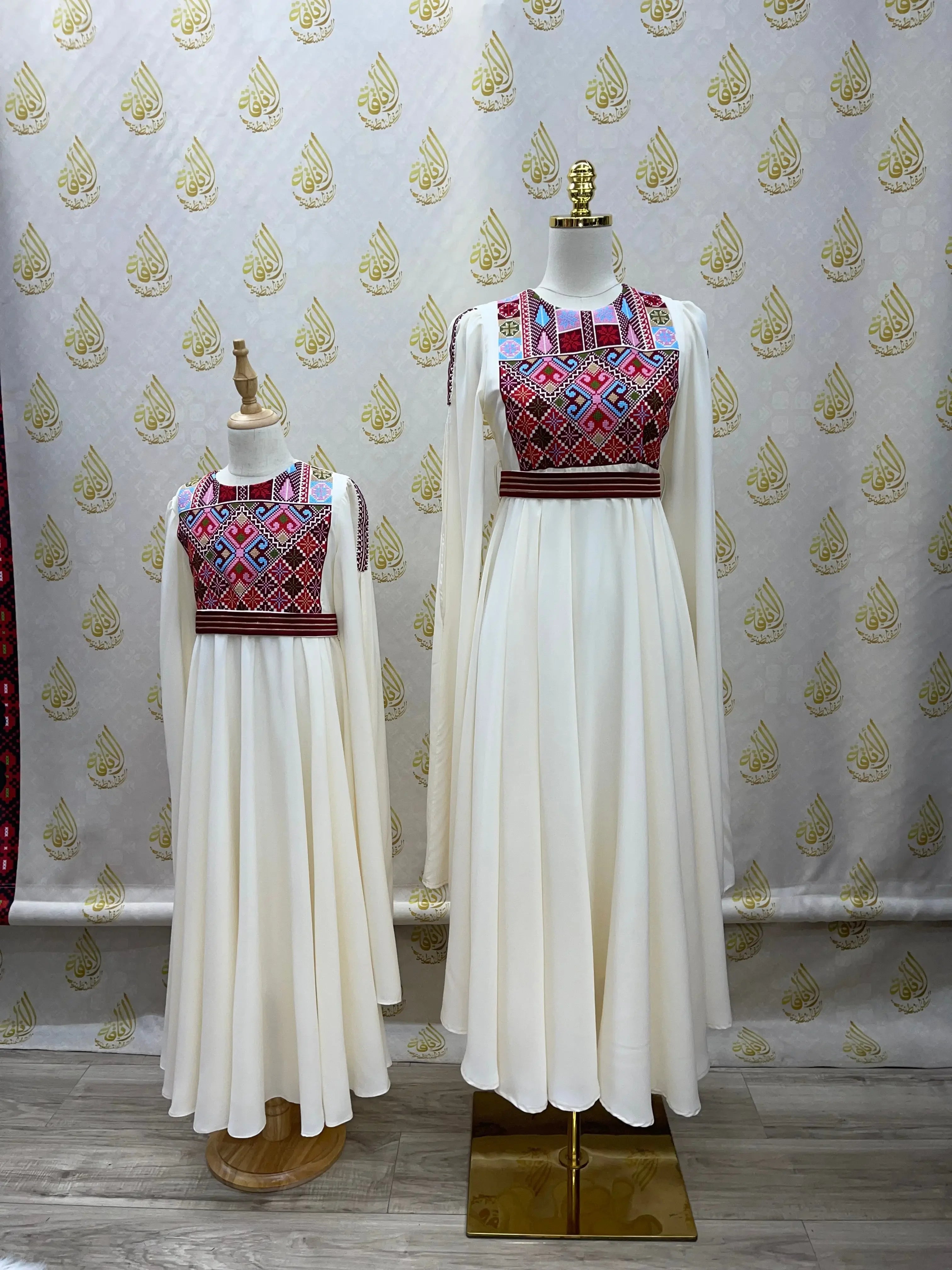 Palestinian girls embroidered dress in white with colorful geometric embroidery on bodice for kids by Palestinian Elegance