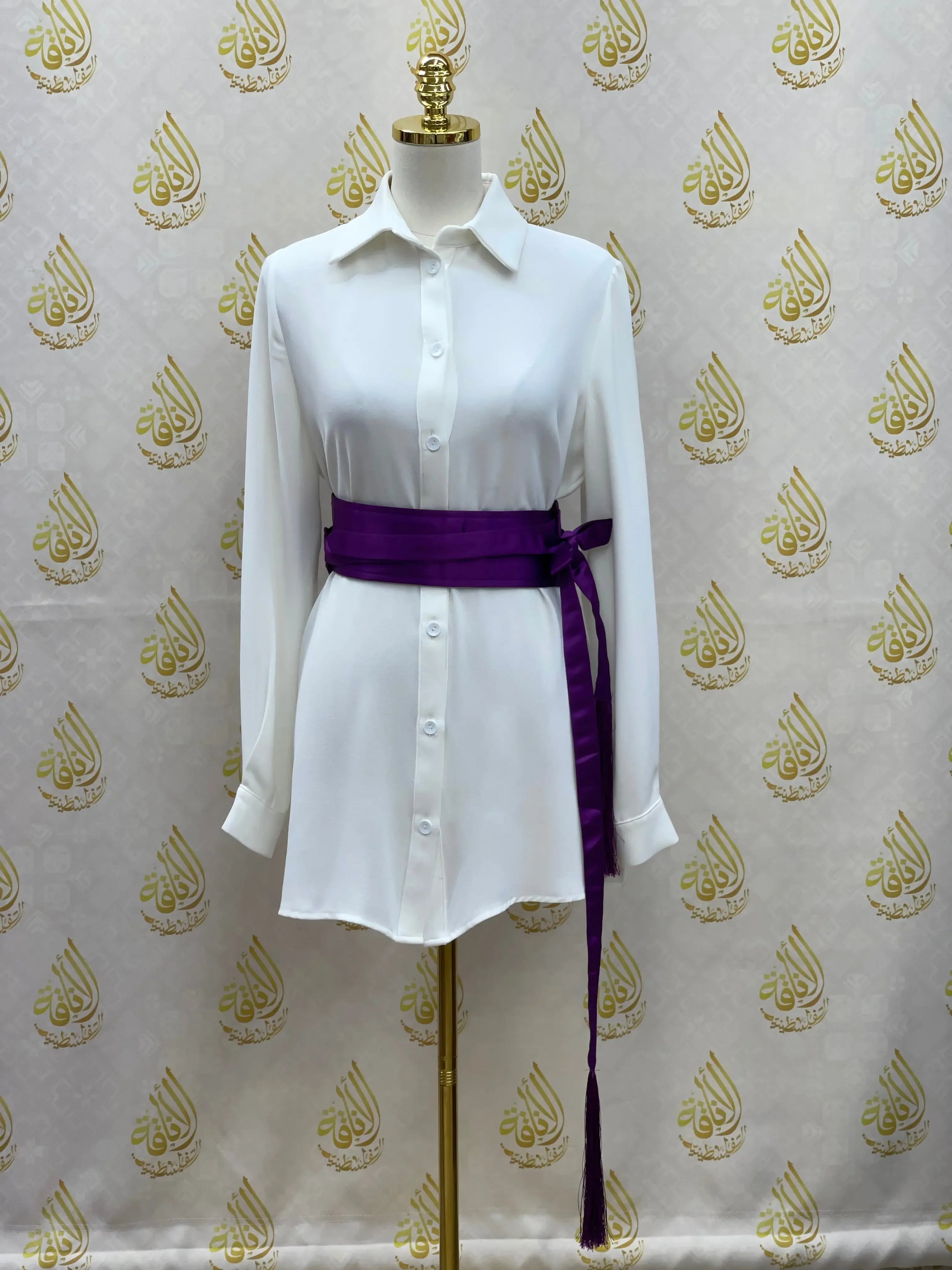 Luxury satin belt for dresses in deep purple wrapped around white button-down dress on mannequin