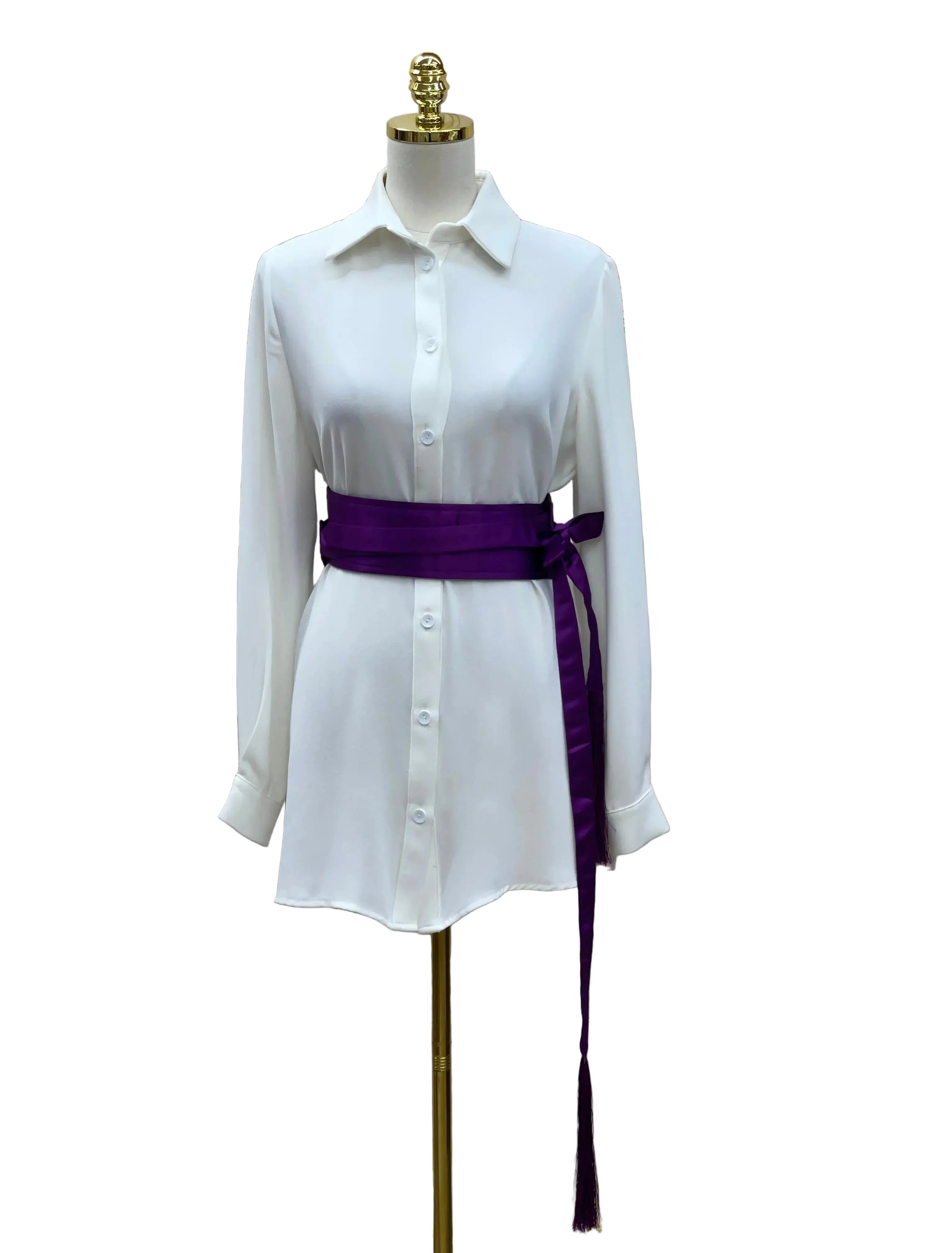 Luxury satin belt for dresses in deep purple wrapped around white button-down dress on mannequin