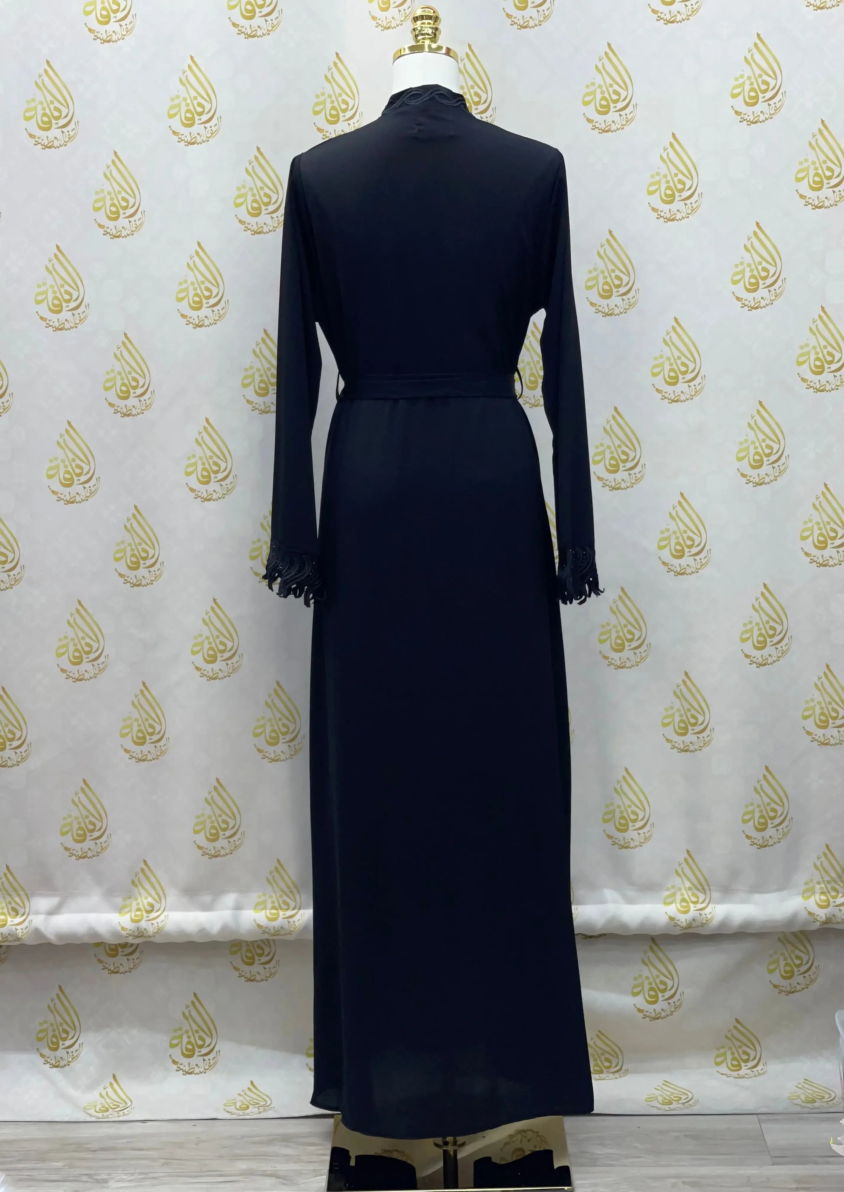 Back view of elegant embroidered abaya in black by Palestinian Elegance with long sleeves and detailed cuffs
