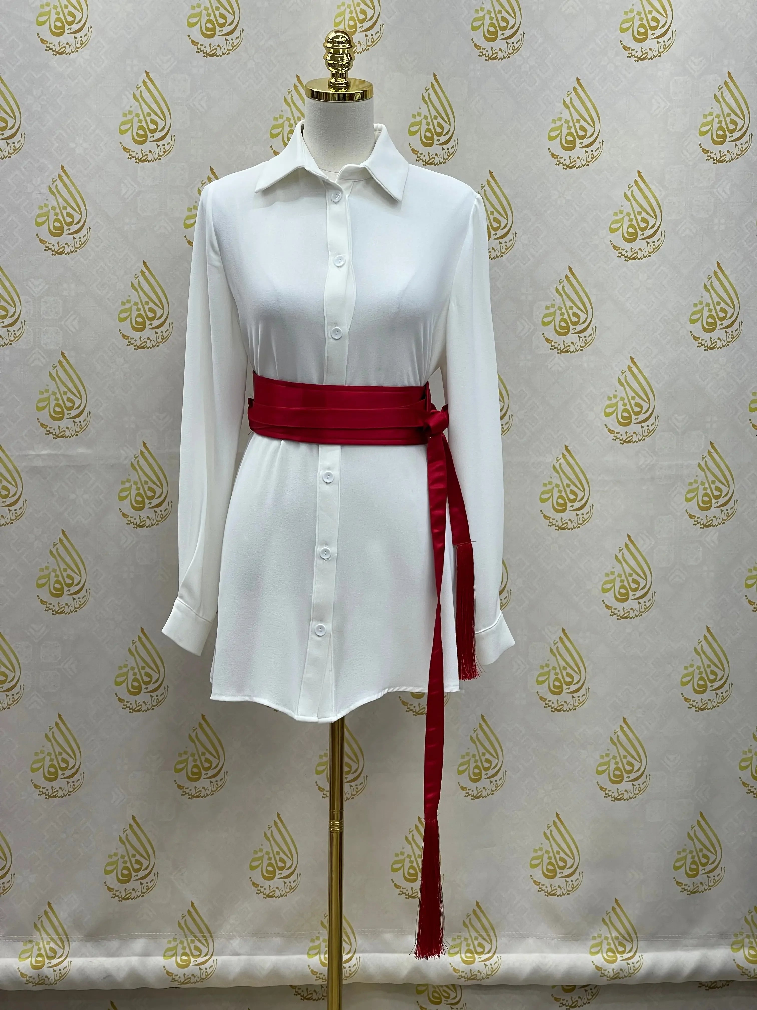 Luxury satin belt for dresses in deep red wrapped around white button-up shirt on mannequin