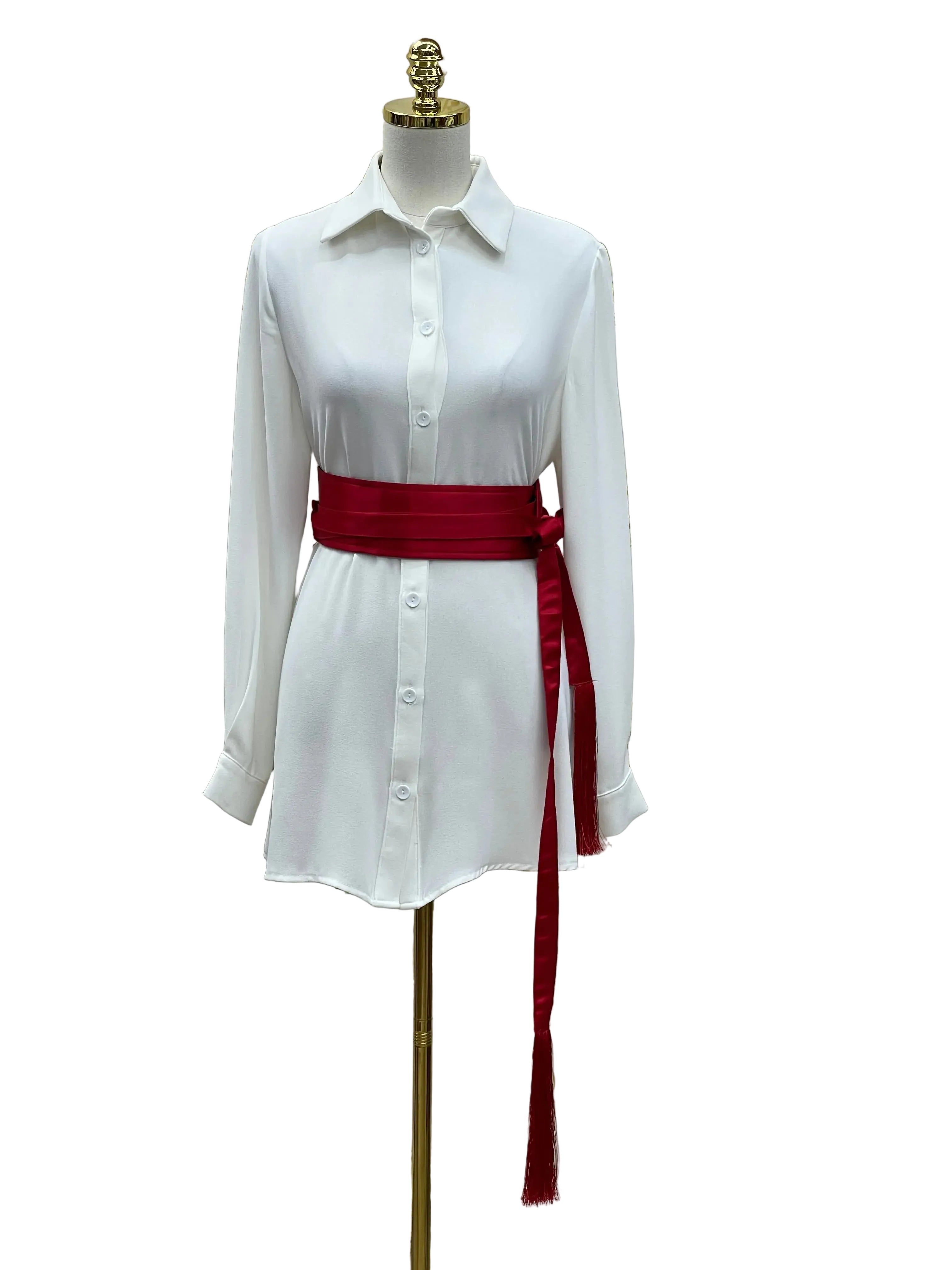 Luxury satin belt for dresses in deep red wrapped around white button-up shirt on mannequin