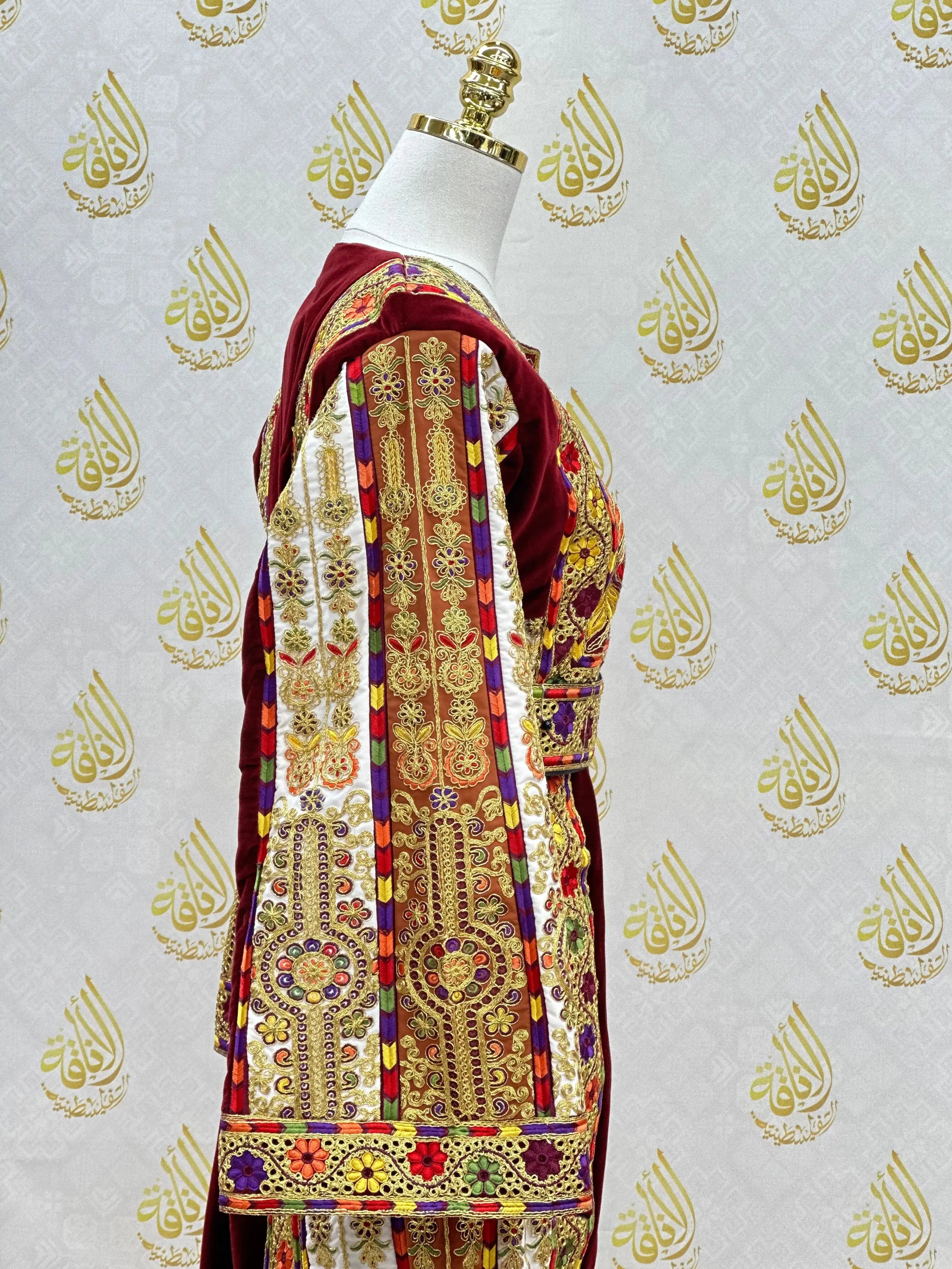 Velvet Palestinian dress with intricate gold and colorful traditional Palestinian embroideries by Palestinian Elegance