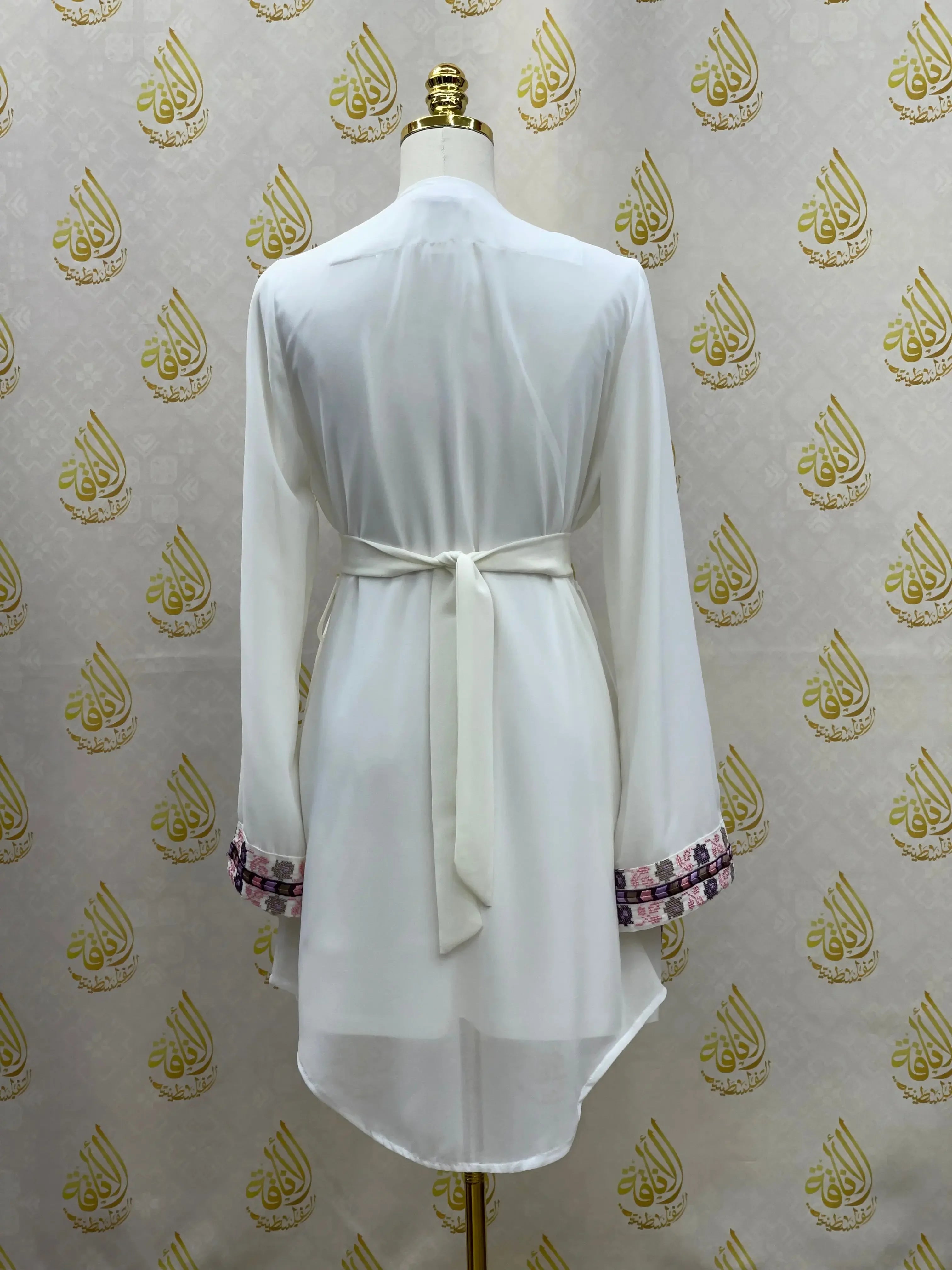 Back view of Palestinian Elegance white embroidered chiffon kimono cardigan with belt and patterned sleeve cuffs