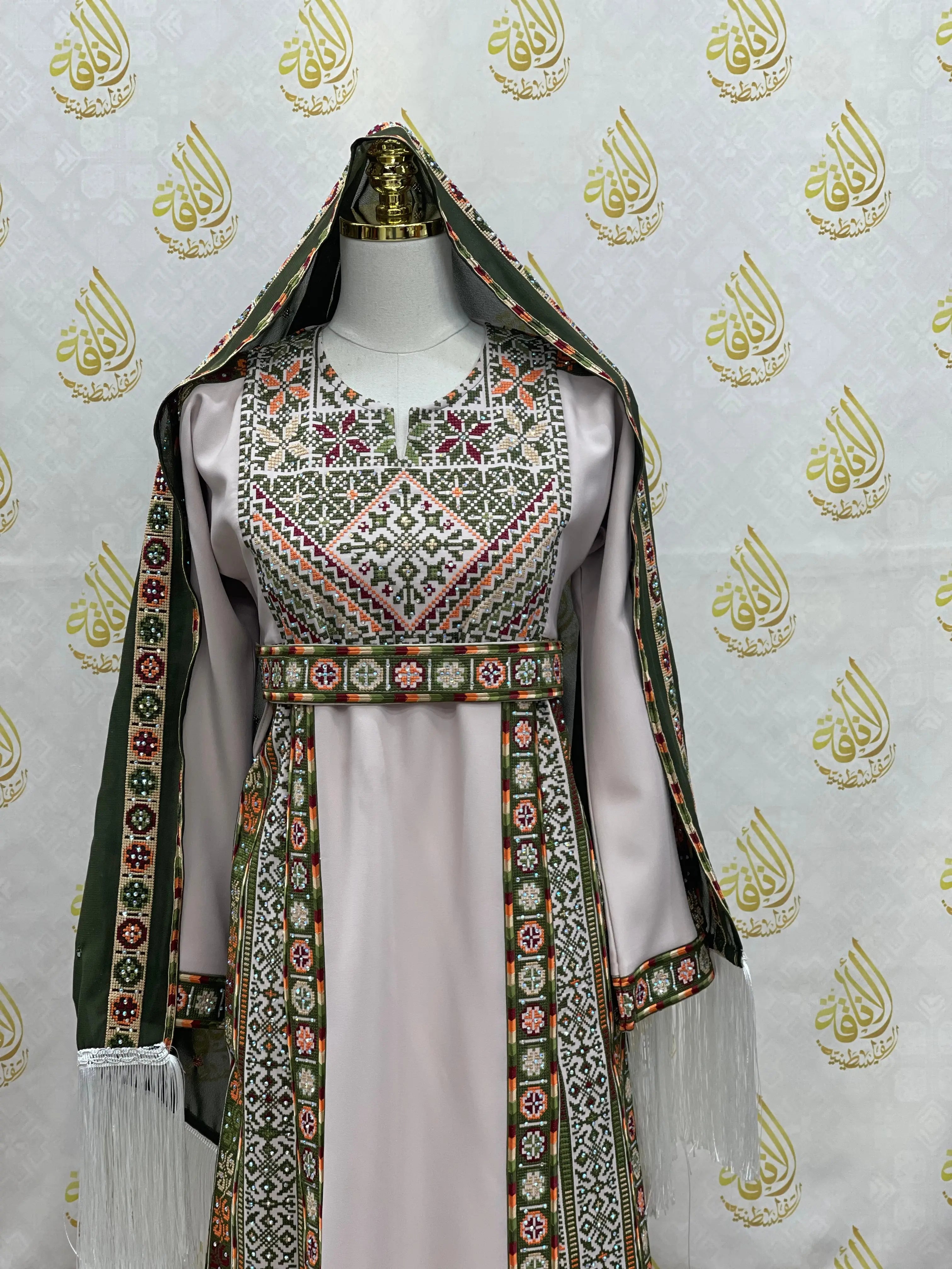 Palestinian Elegance embroidered traditional dress with intricate green floral patterns and matching headscarf