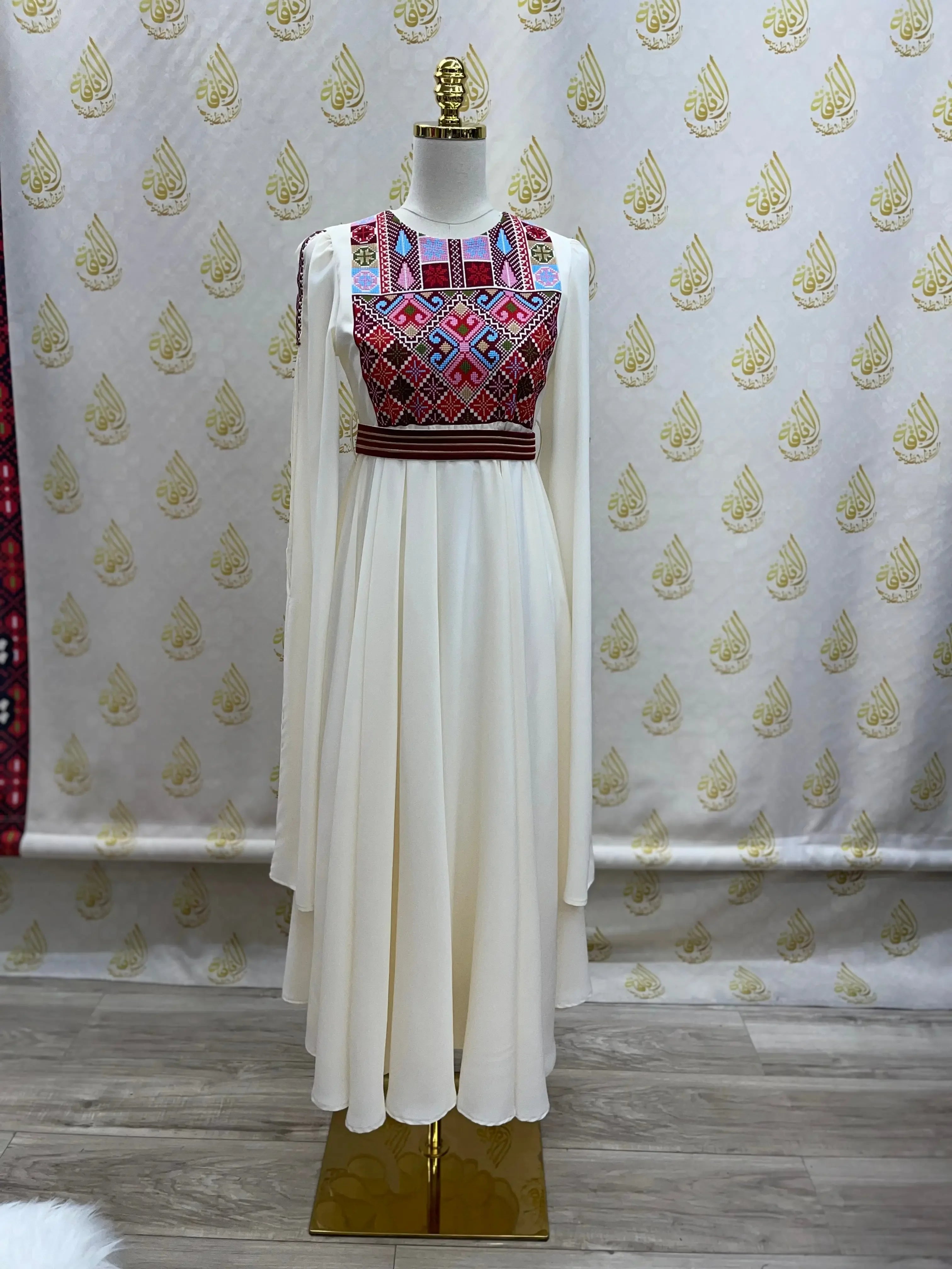 Palestinian girls embroidered dress with traditional colorful embroidery and flowing white fabric