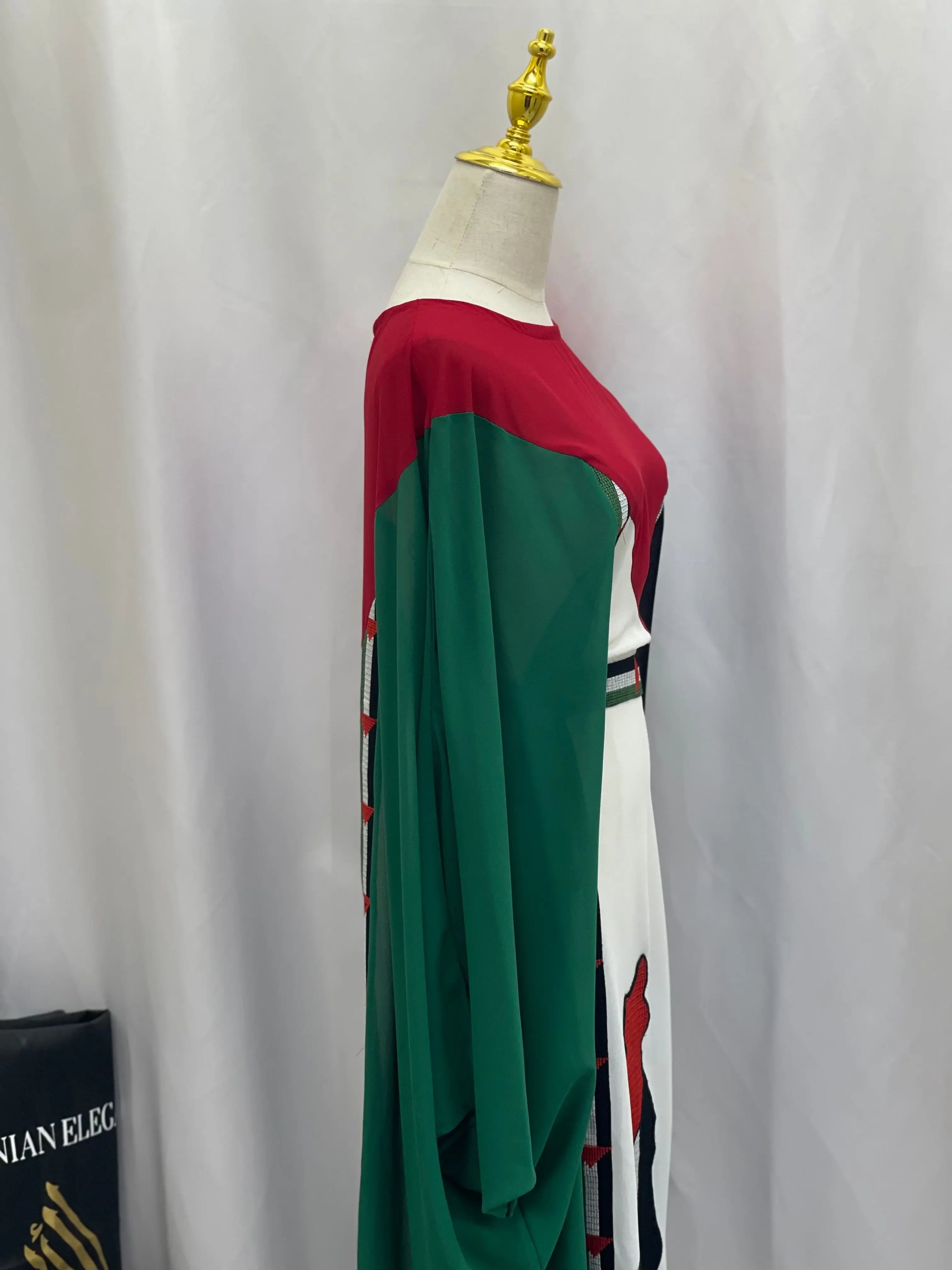 Side view of Palestinian flag dress by Palestinian Elegance featuring red, green, and white colors with casual fit