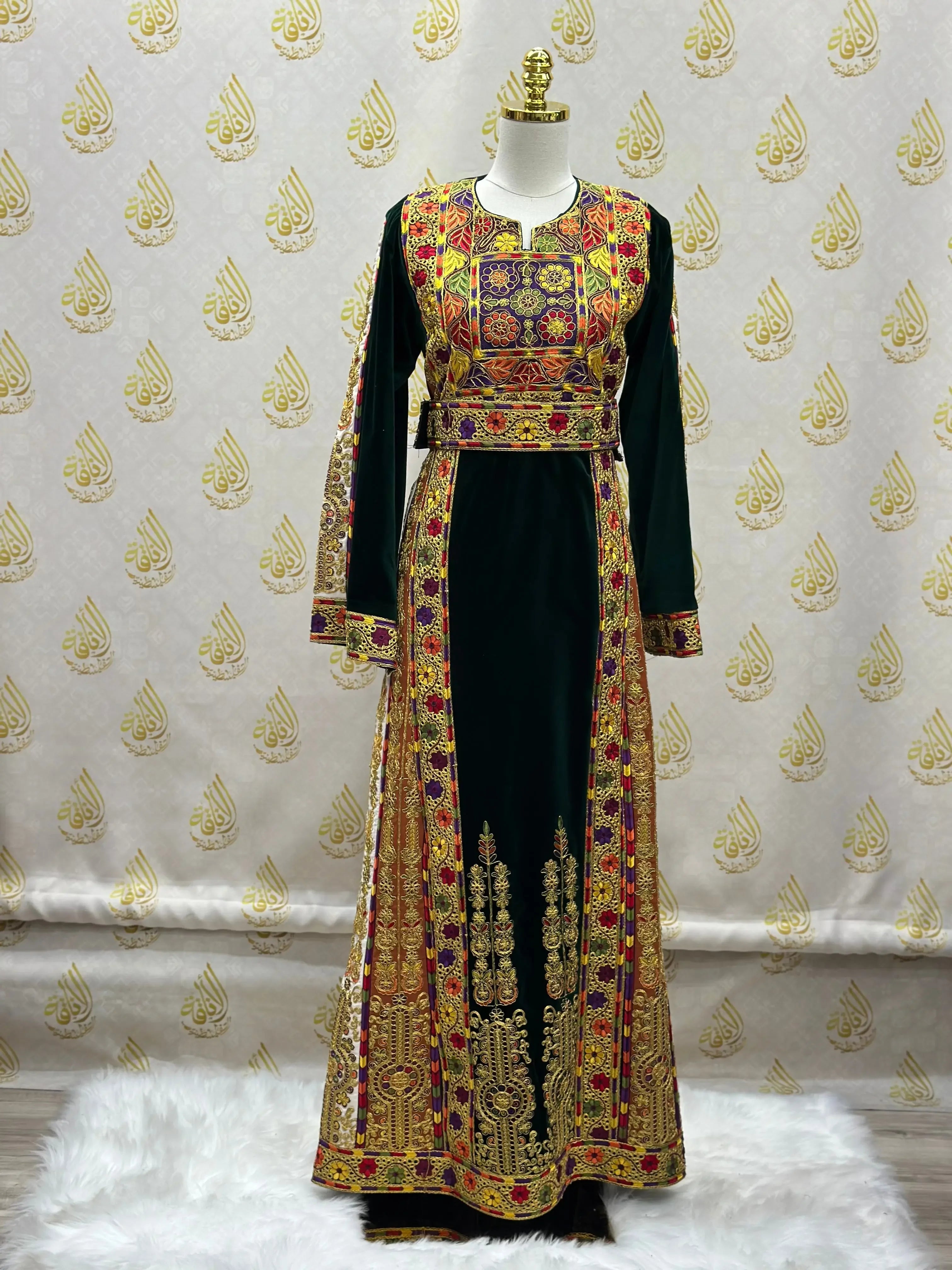 Velvet Palestinian dress with intricate embroidery from Palestinian Elegance displayed on a mannequin