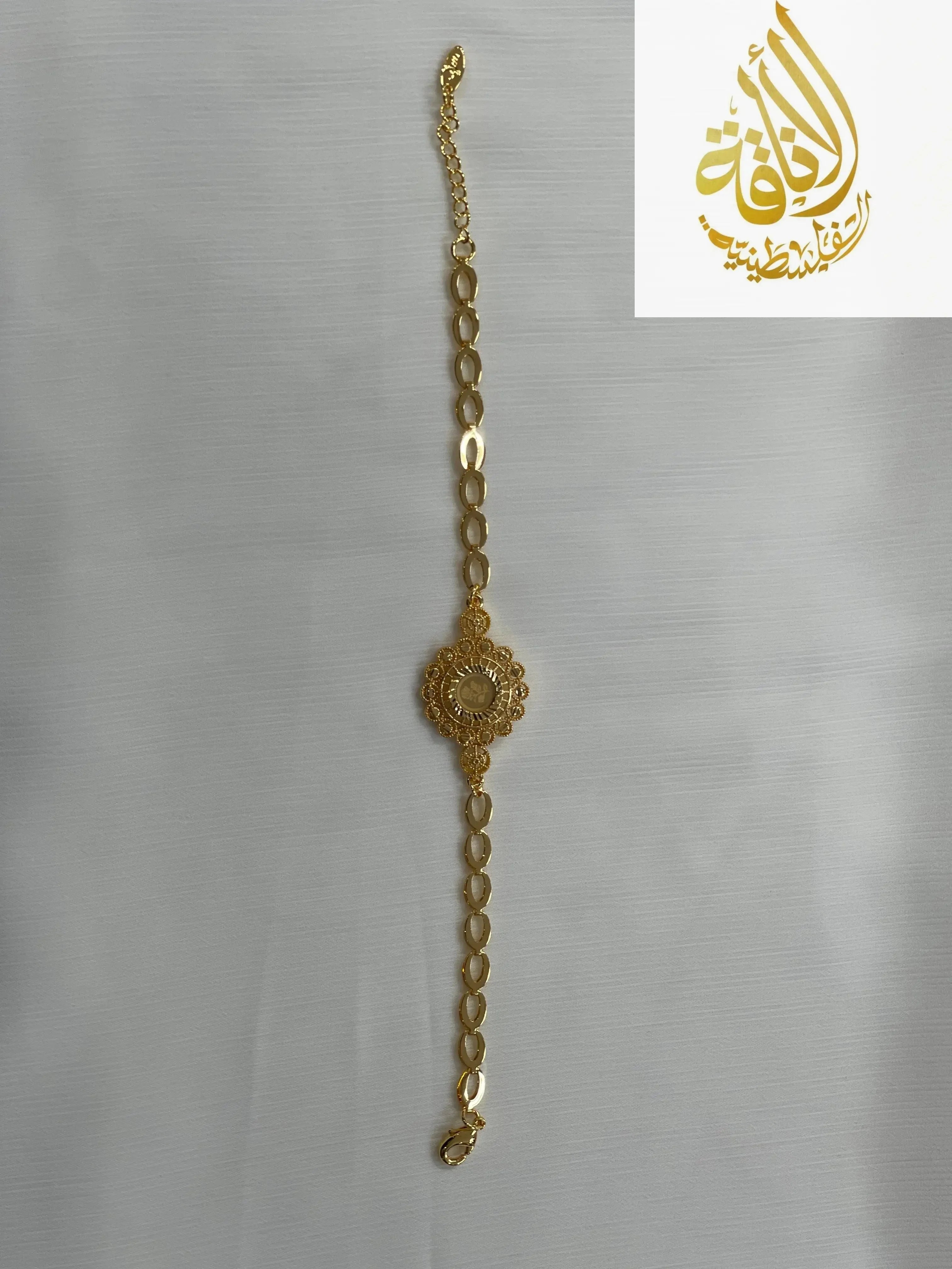 Palestinian Elegance gold jewelry set for women featuring a delicate linked chain bracelet with ornate central design