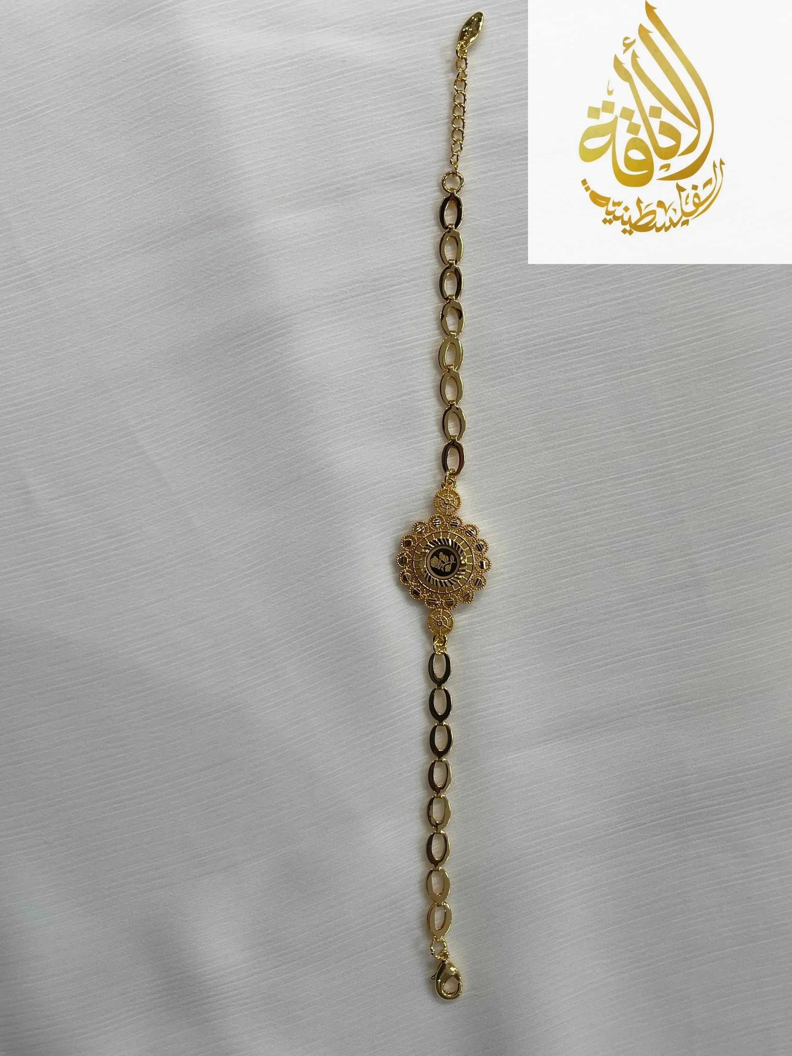 Delicate gold jewelry set for women featuring an elegant linked bracelet with a floral centerpiece