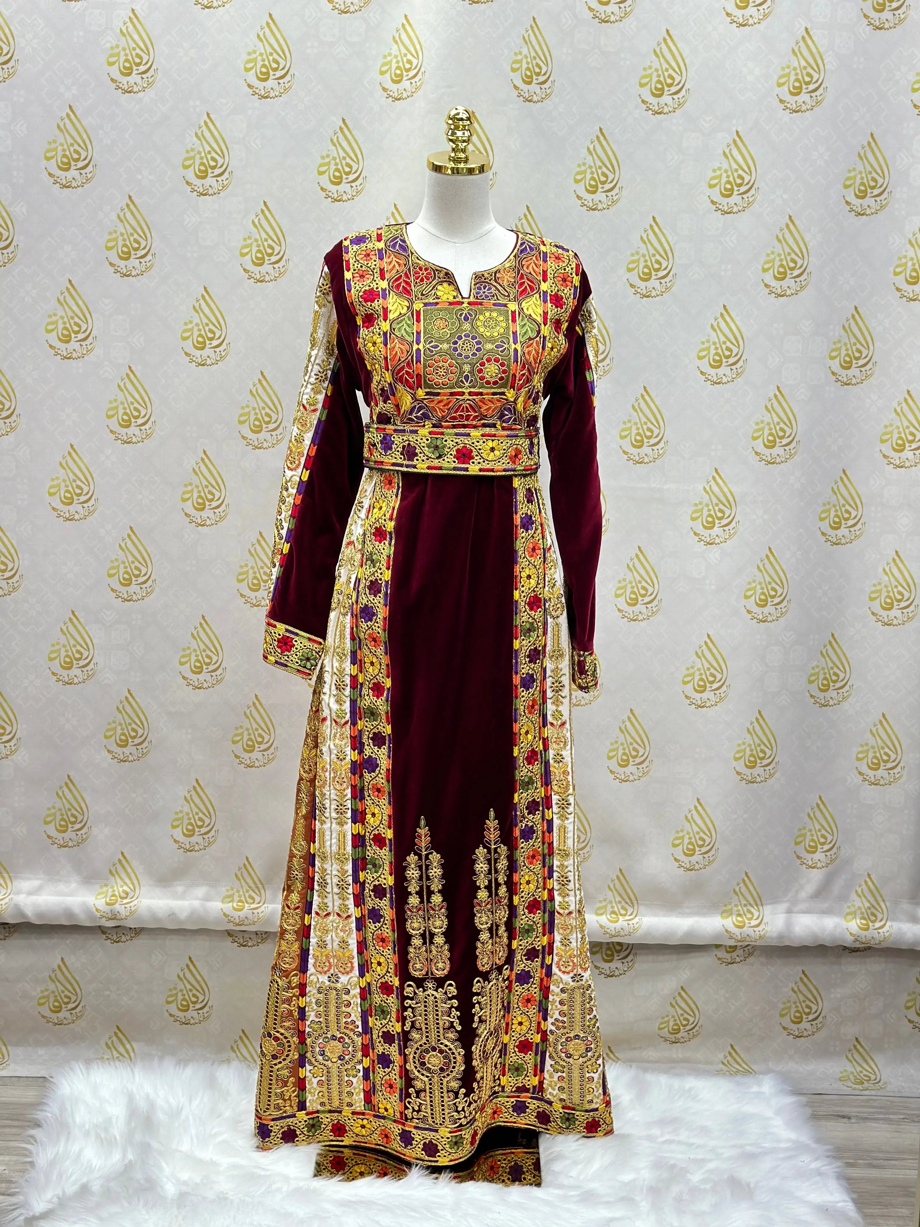 Velvet Palestinian dress with intricate gold and colorful embroidery from Palestinian Elegance