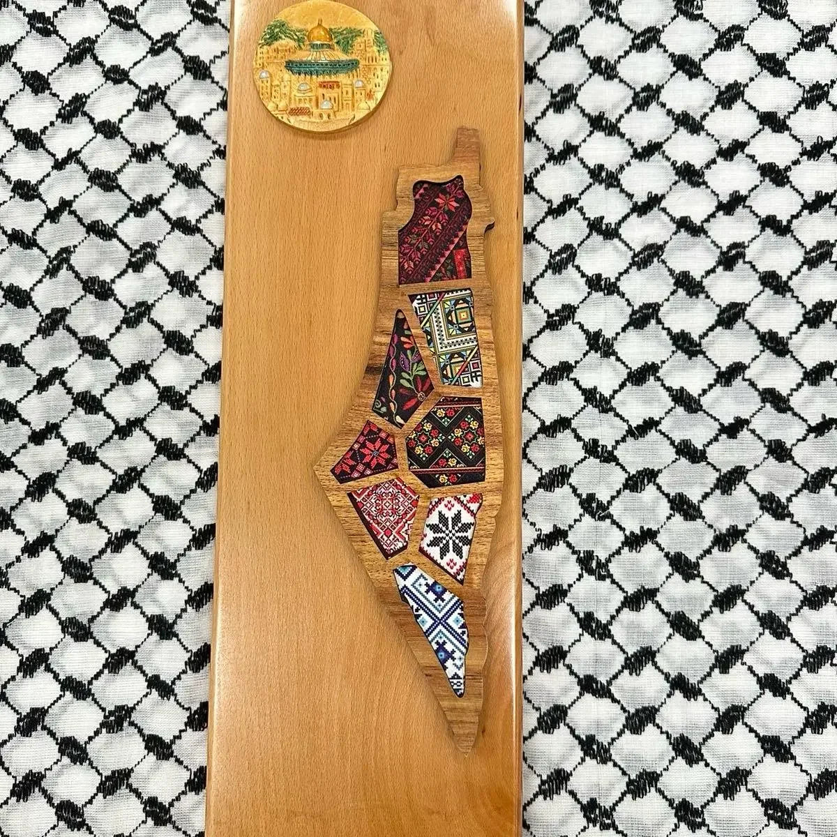 Handmade Palestine map wall art with traditional embroidered patterns on wooden board