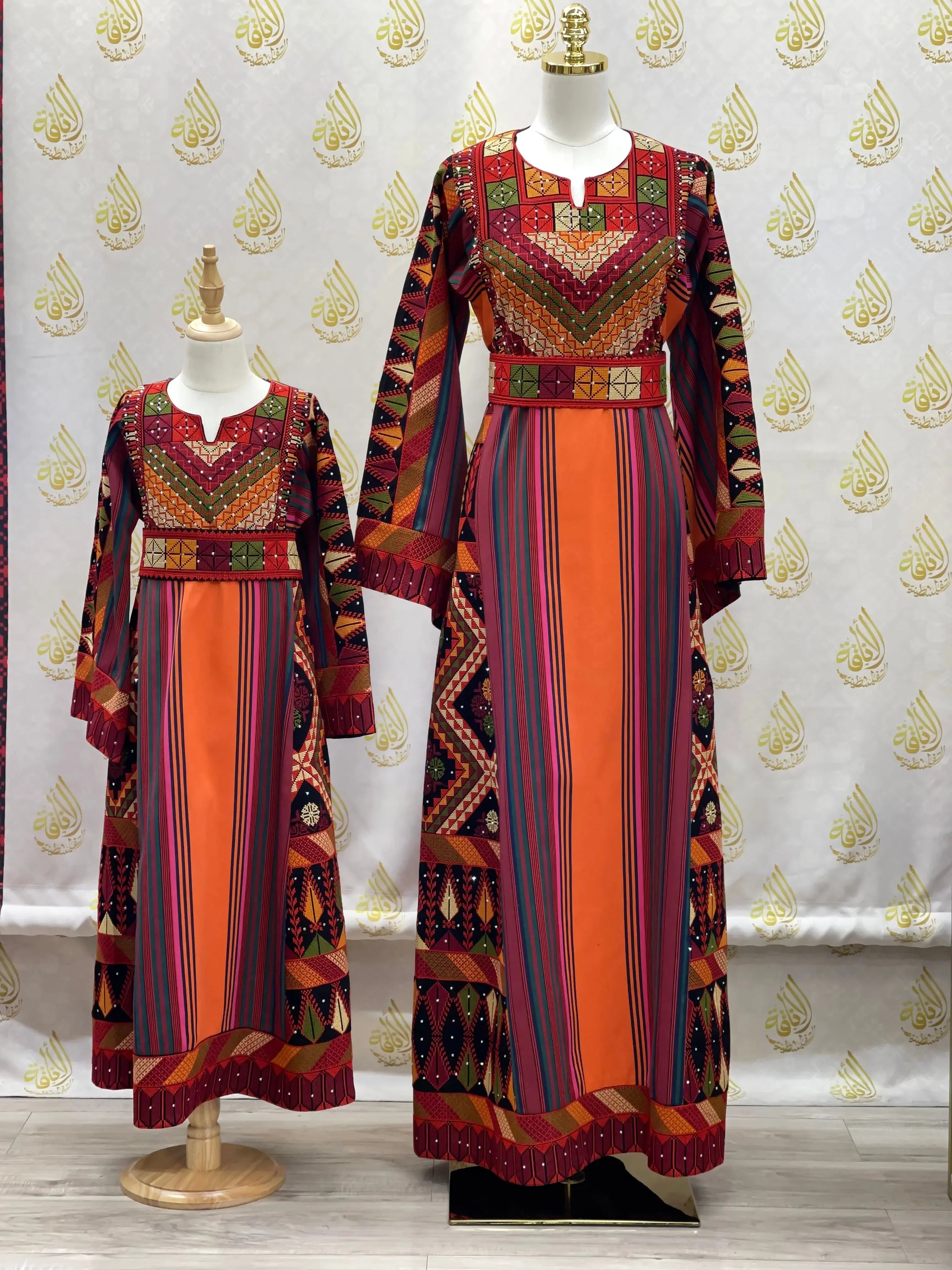 Luxury Palestinian thoub dress embroidery with vibrant multicolor patterns on two mannequins by Palestinian Elegance