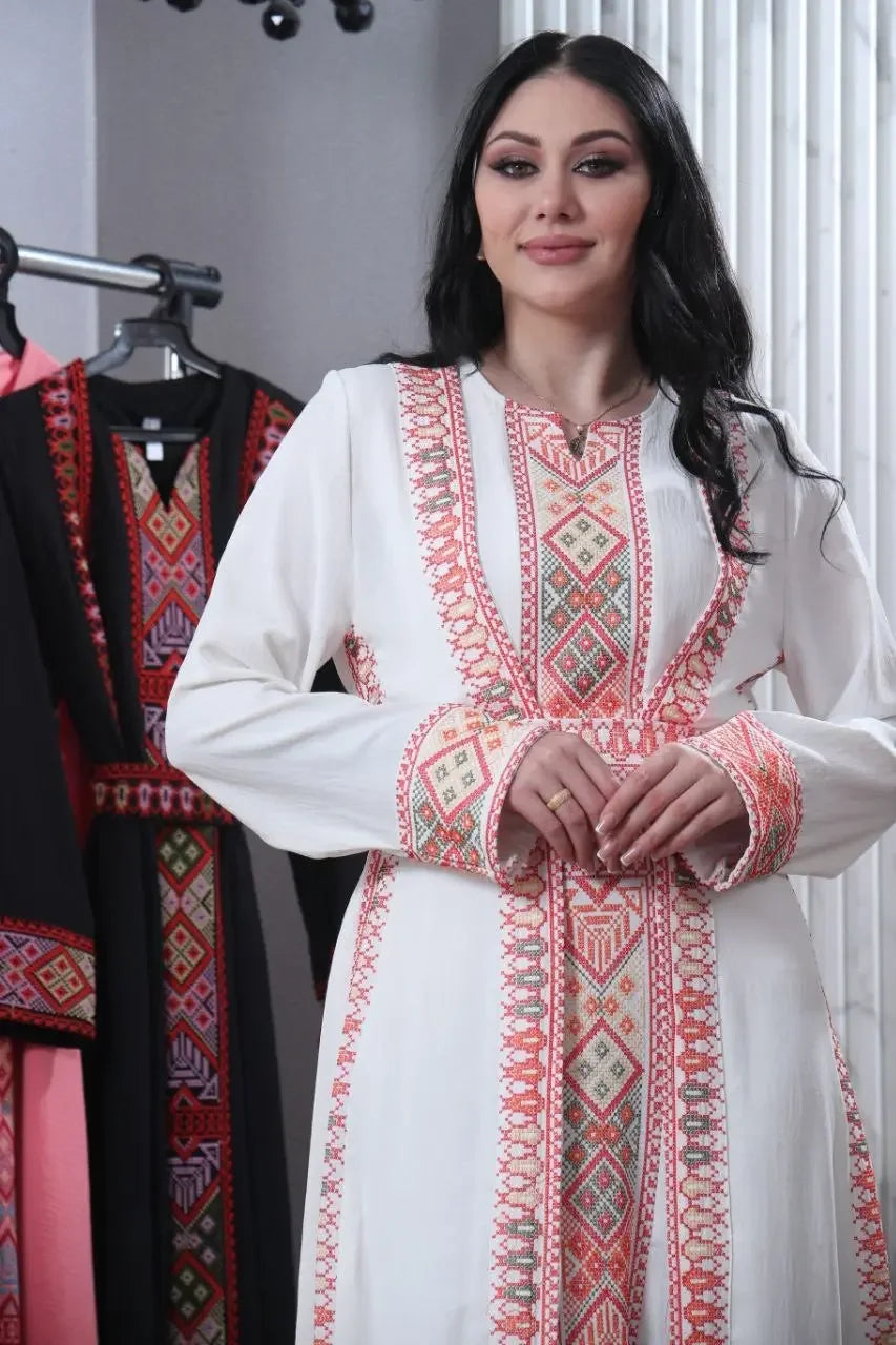 Palestinian Elegance embroidered abaya for women in white with intricate pink and red geometric designs