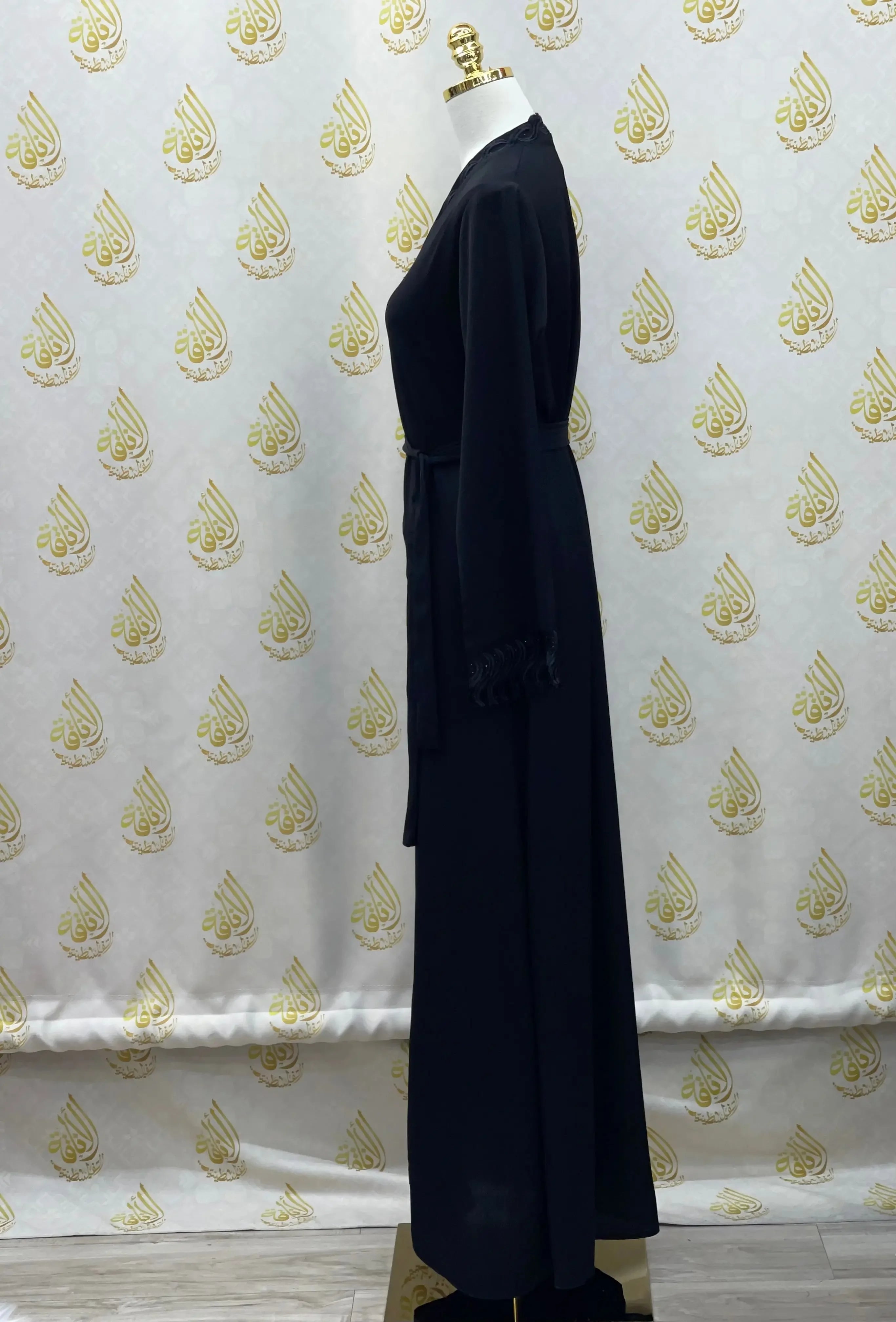 Palestinian Elegance elegant embroidered abaya in black with long sleeves displayed on mannequin