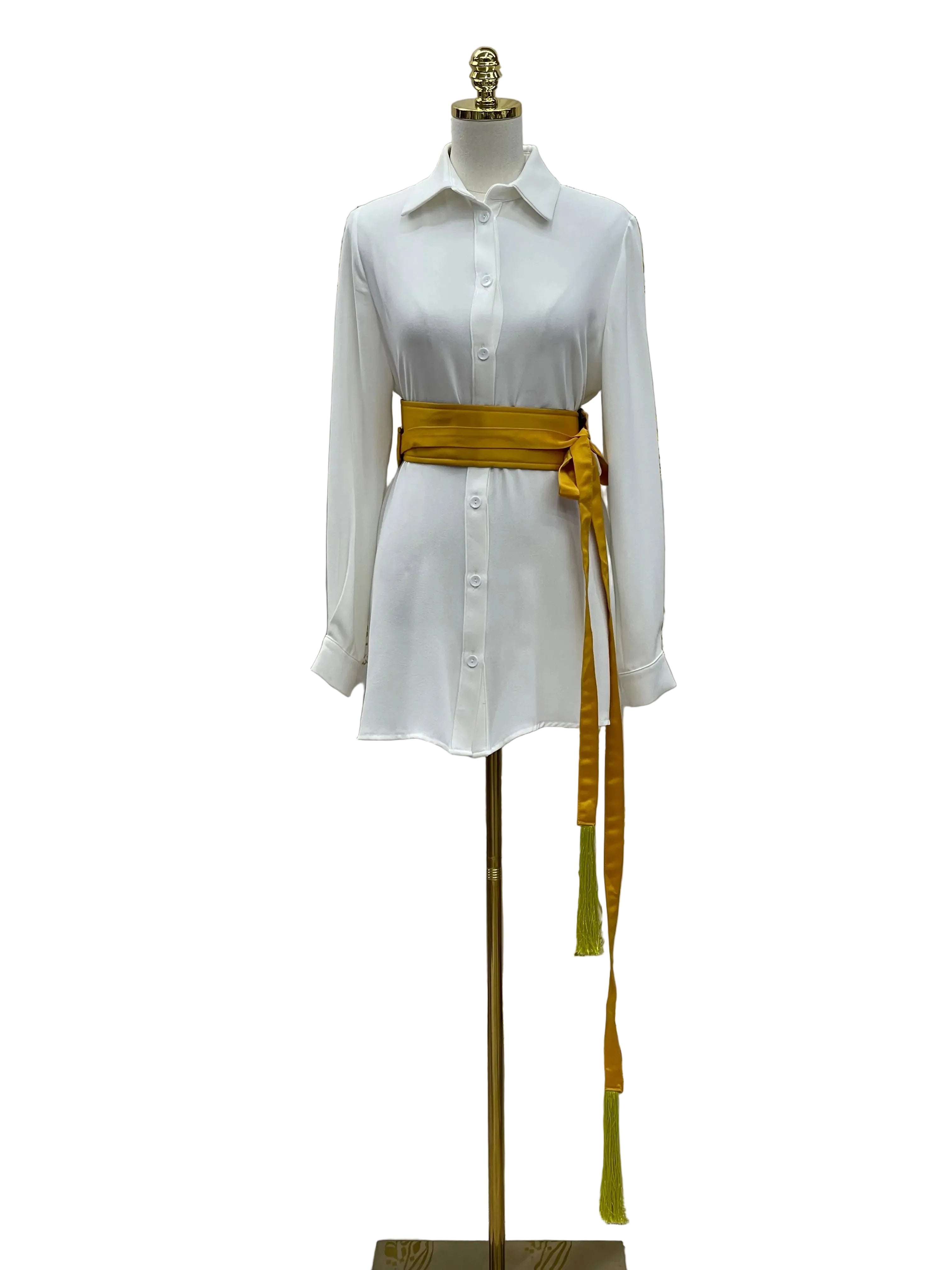 Luxury satin belt for dresses in gold wrapped around white button-down shirt dress on mannequin
