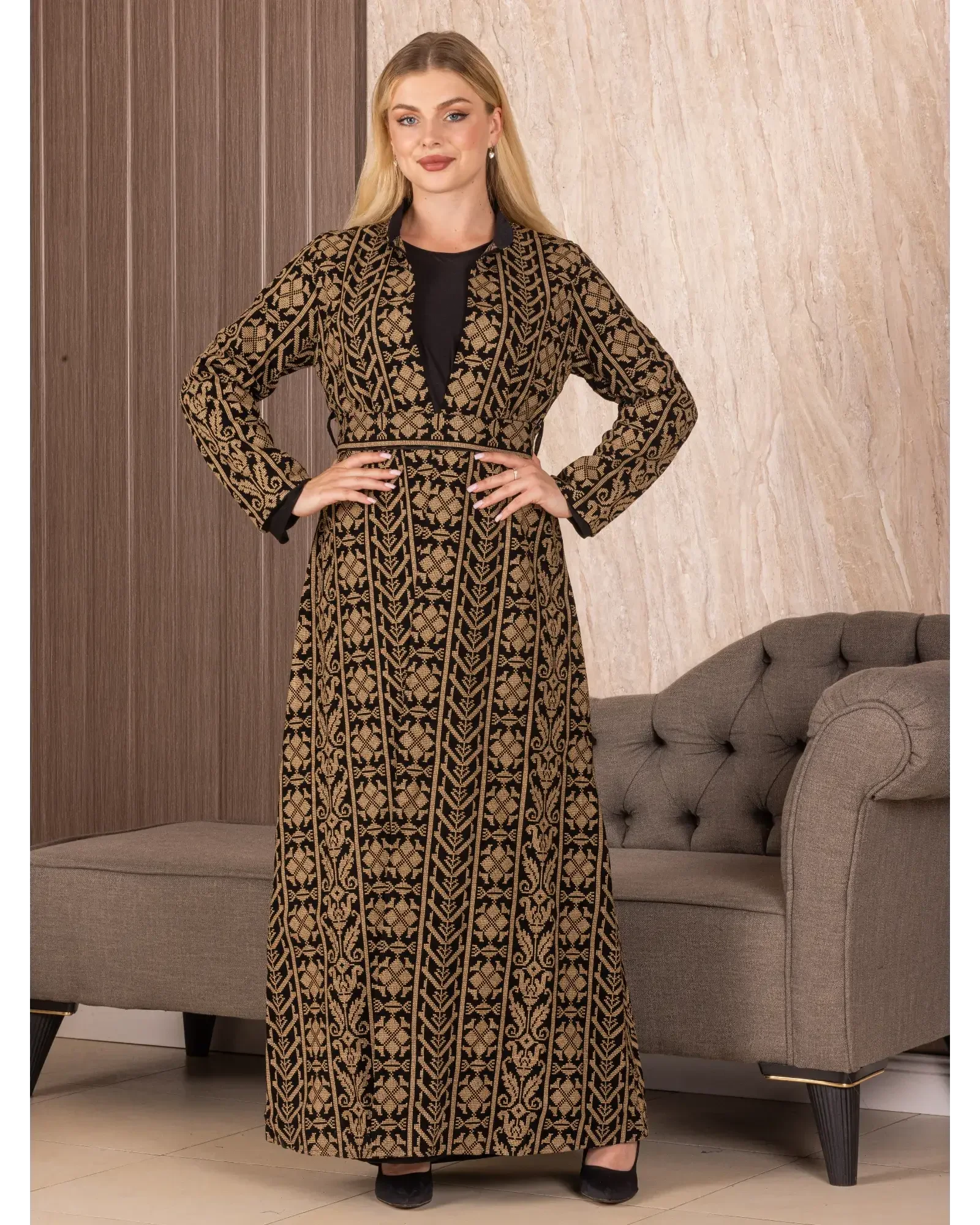 Palestinian Elegance embroidered long cardigan with traditional black and gold intricate patterns worn by a woman