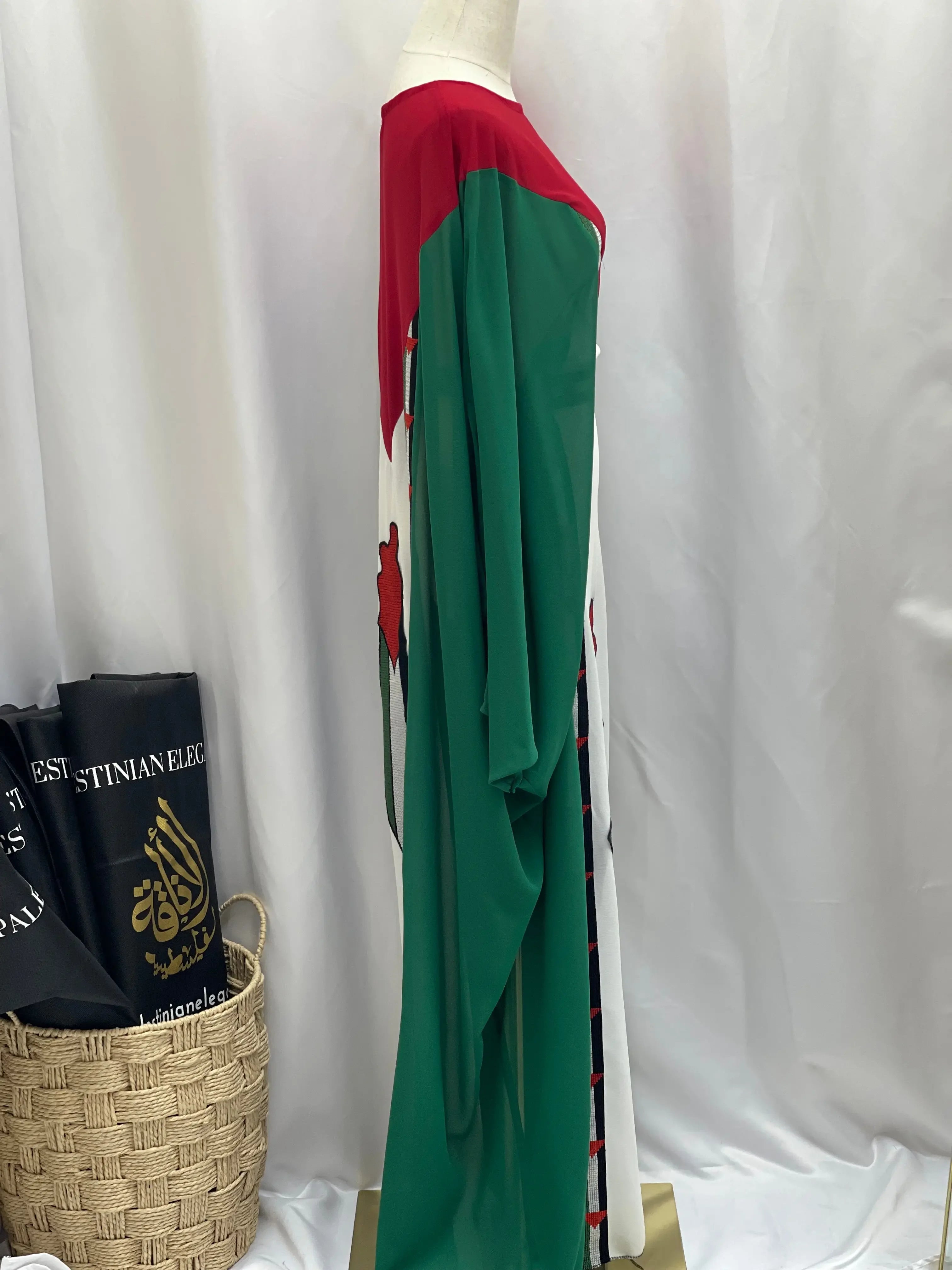 Side view of Palestinian flag dress by Palestinian Elegance featuring green, red, white colors in a casual style