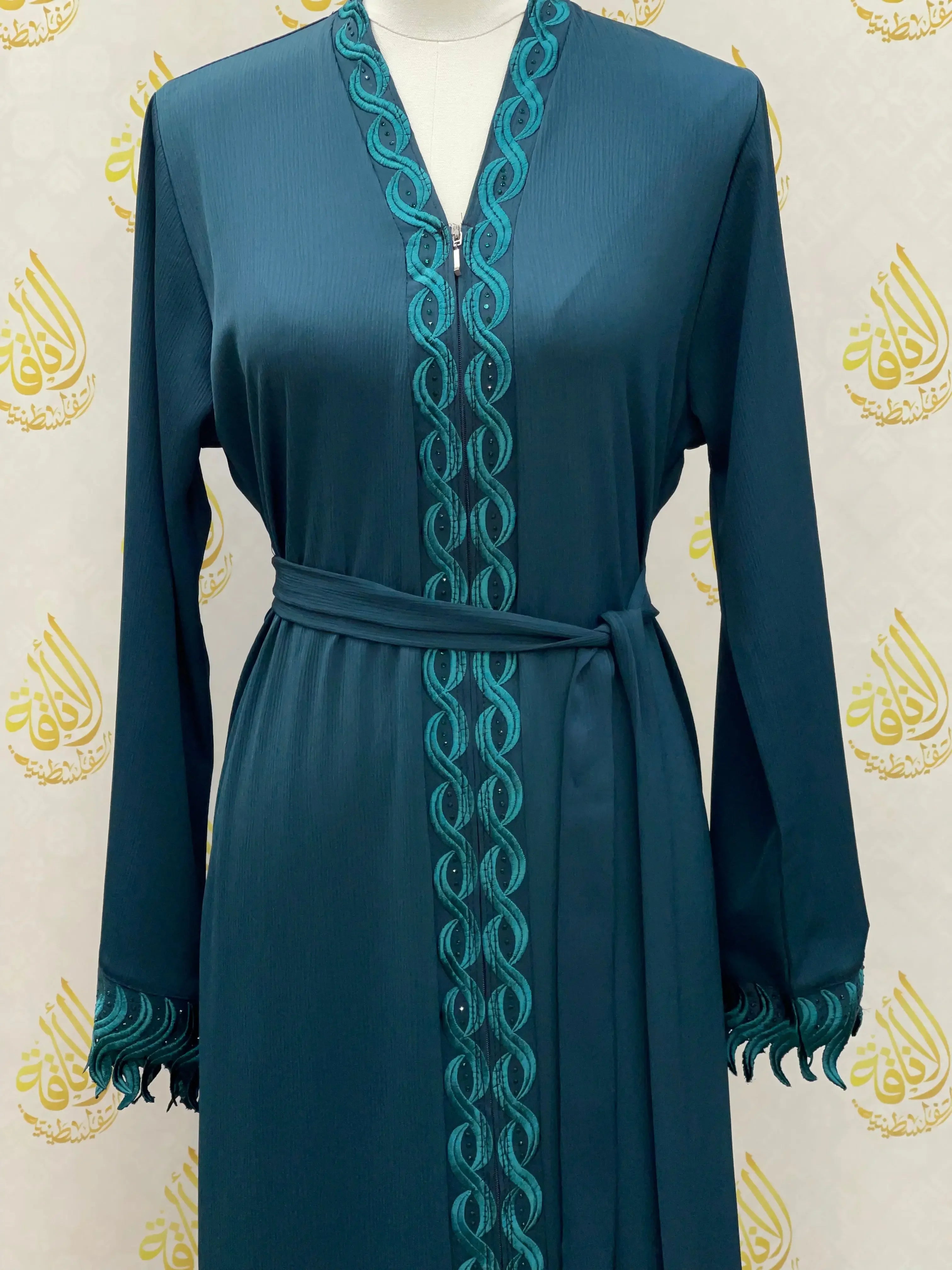 Elegant embroidered abaya in teal with intricate stitching down front and sleeves by Palestinian Elegance