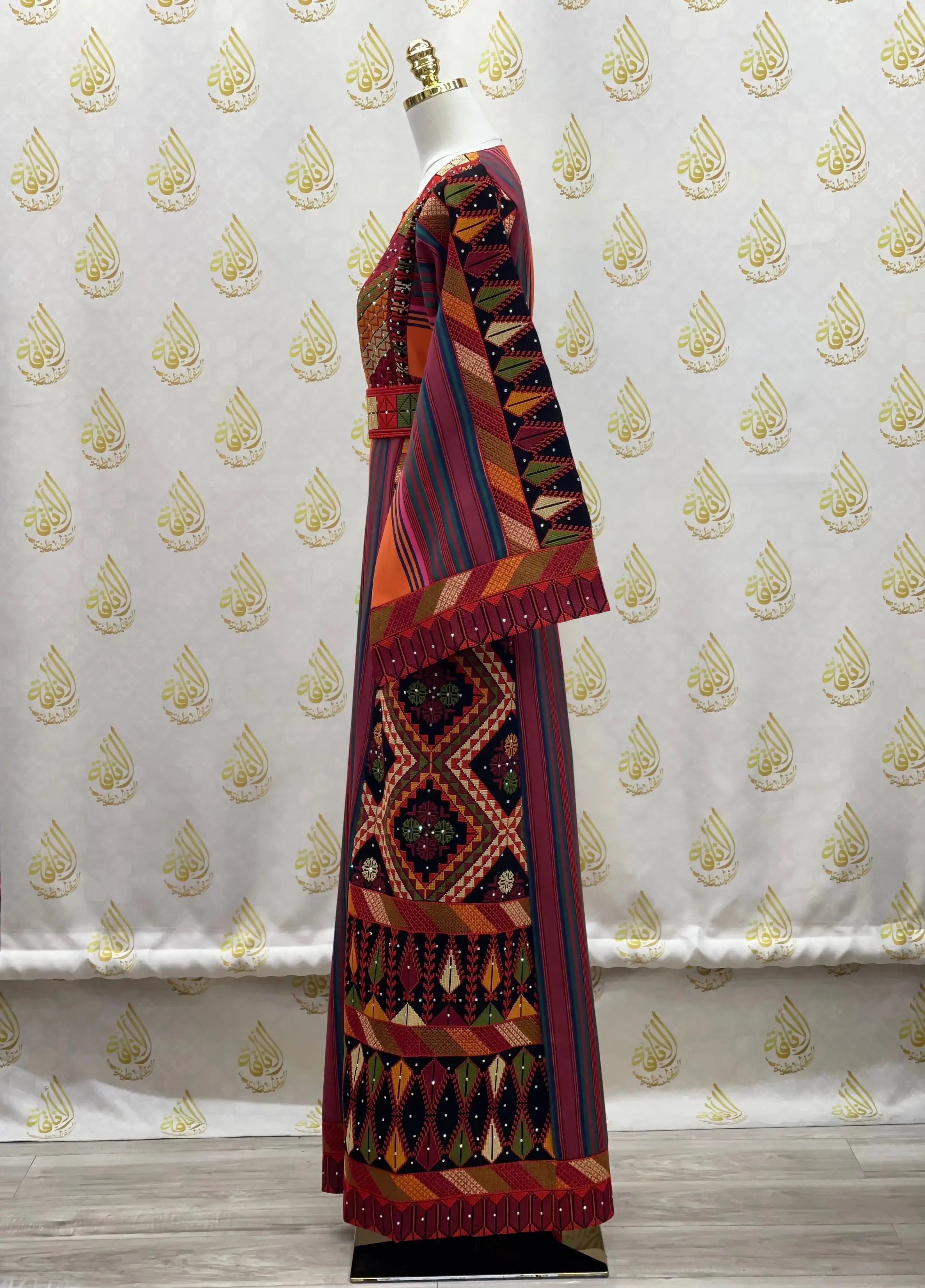 Luxury Palestinian thoub dress with colorful geometric embroidery by Palestinian Elegance on mannequin