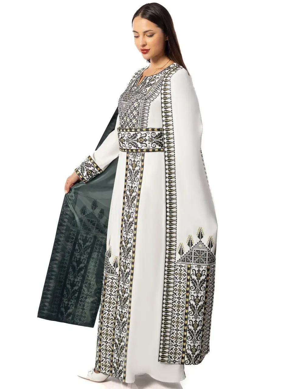 White embroidered Palestinian thobe dress with intricate black and gold embroidery by Palestinian Elegance