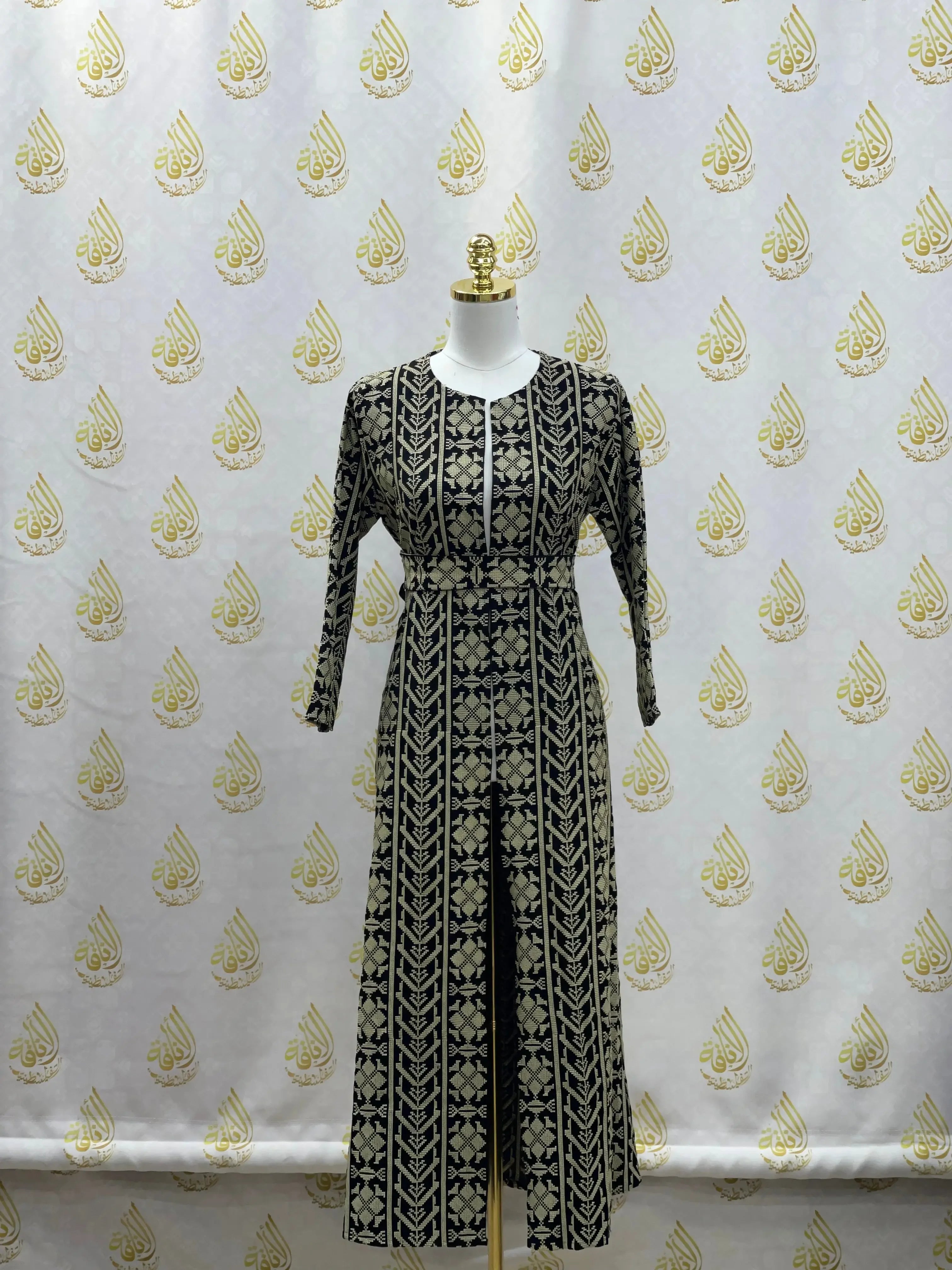 Palestinian Elegance embroidered cardigan for kids with intricate black and beige traditional patterns displayed on mannequin