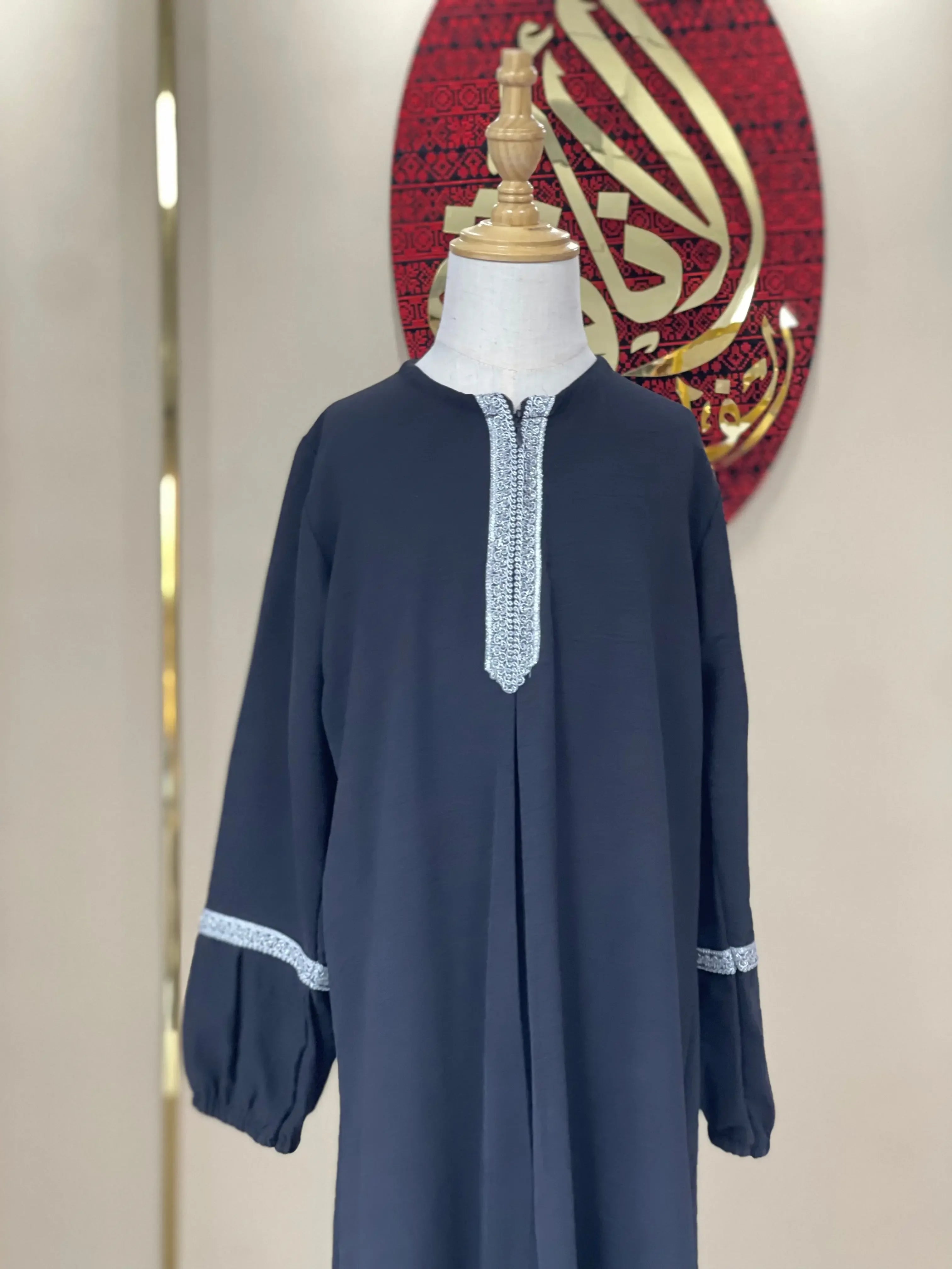 Palestinian Elegance girls embroidered abaya in dark fabric with white embroidery on neckline and sleeves
