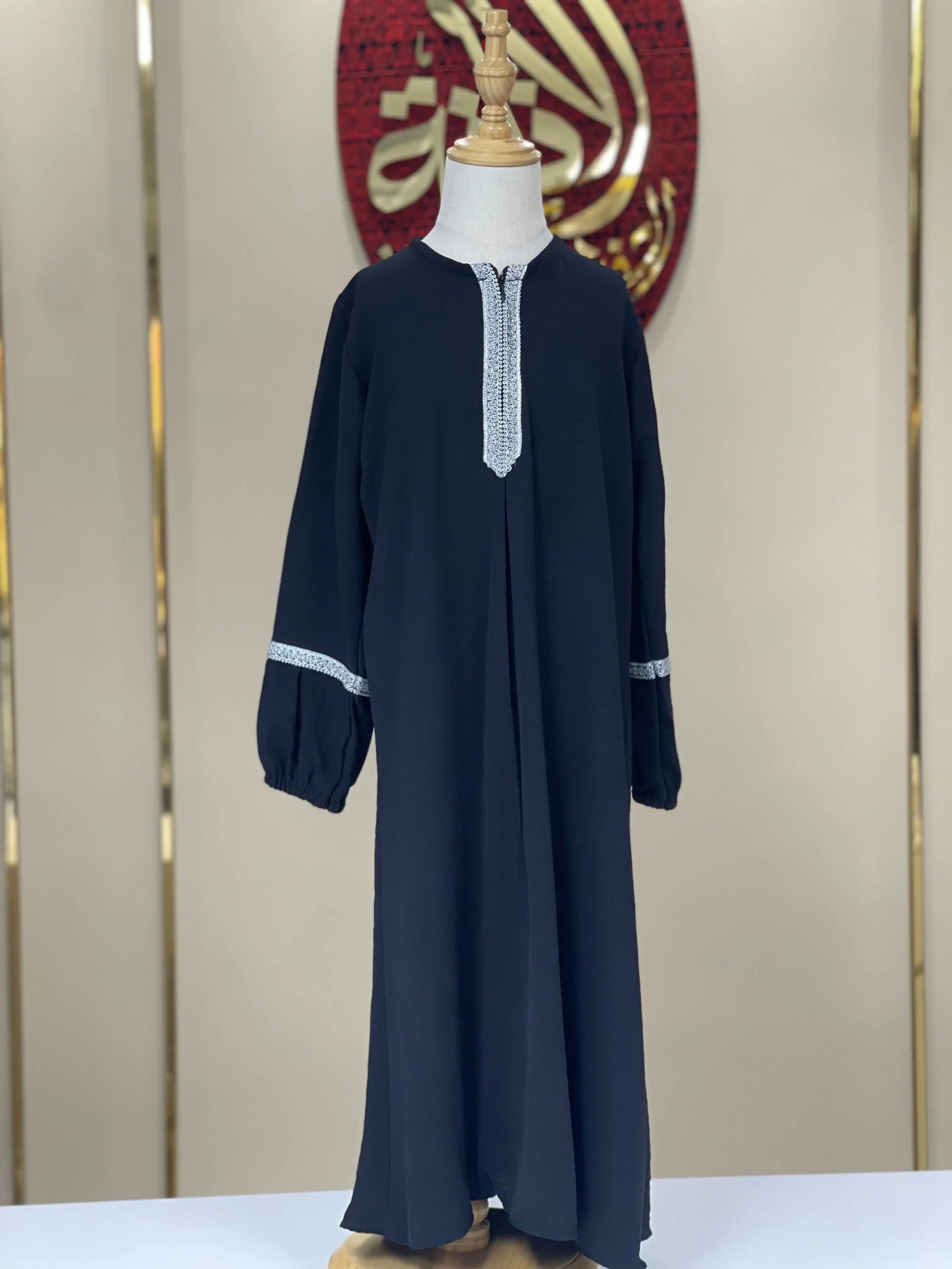 Palestinian Elegance girls embroidered abaya in black with white embroidered neckline and sleeve details for kids
