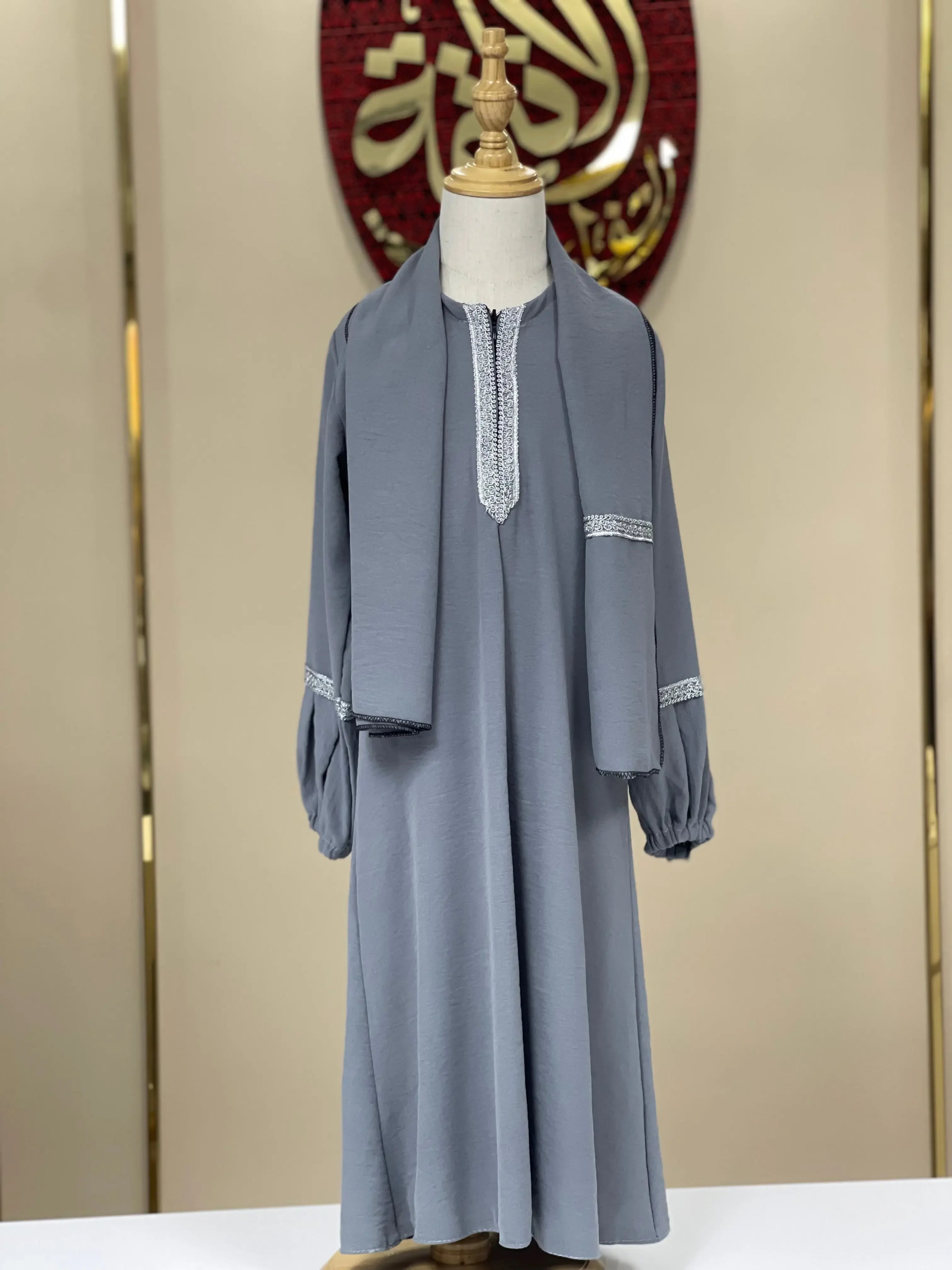 Girls embroidered abaya in gray with detailed silver embroidery on sleeves and neckline from Palestinian Elegance