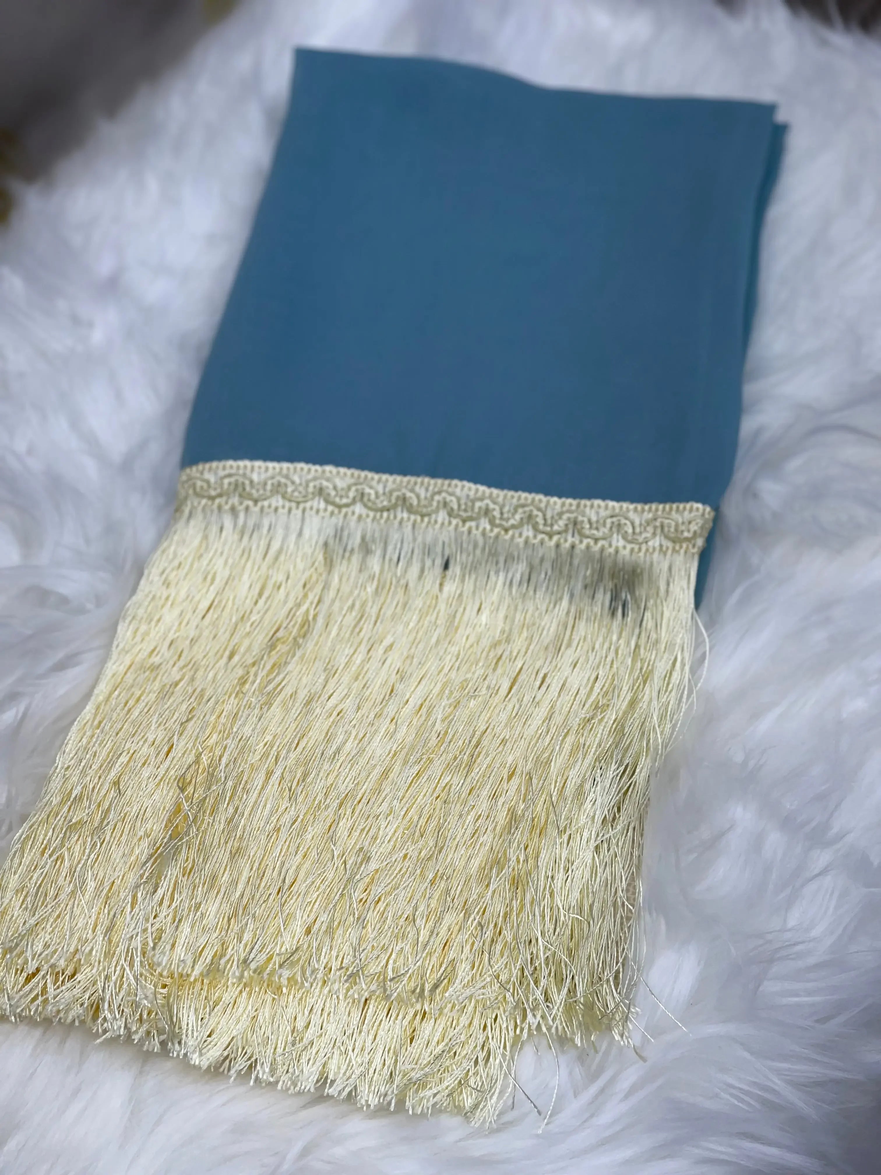 Traditional Palestinian khirka shawl by Palestinian Elegance with blue fabric and cream fringe detail