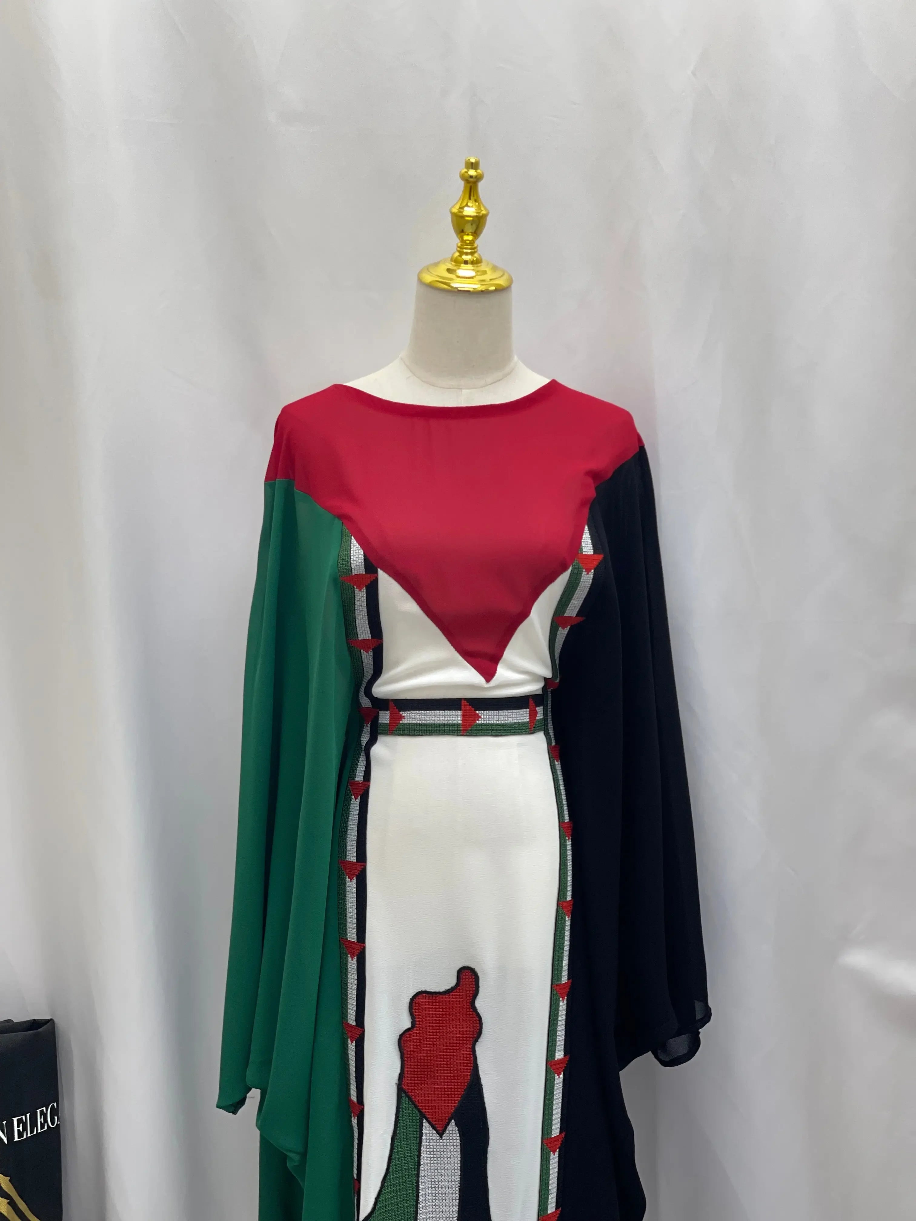 Palestinian flag dress by Palestinian Elegance with red, green, black, and white colors in casual style