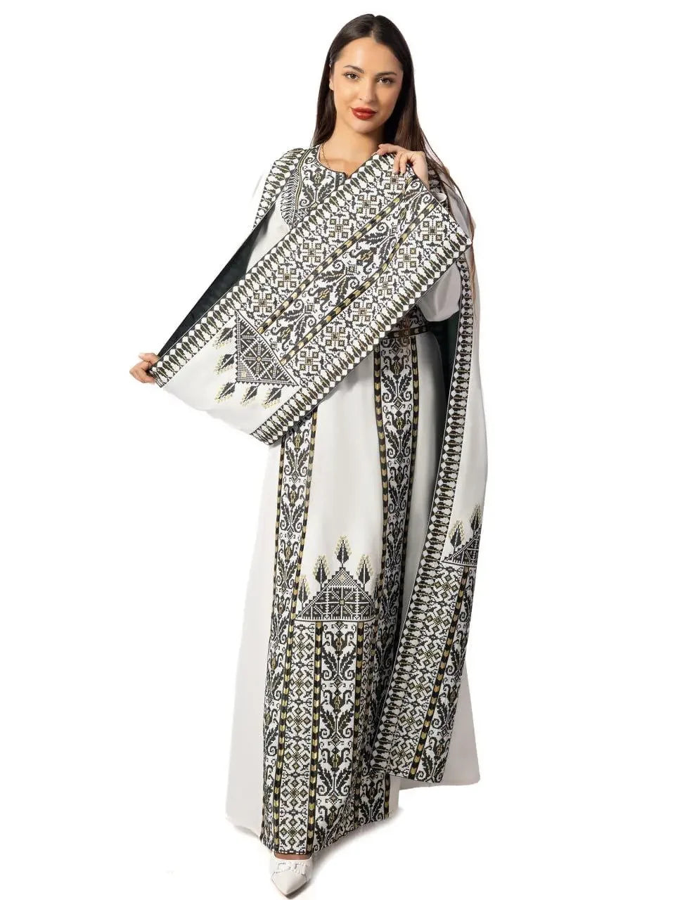 Woman wearing embroidered Palestinian thobe dress with detailed black and gold traditional patterns