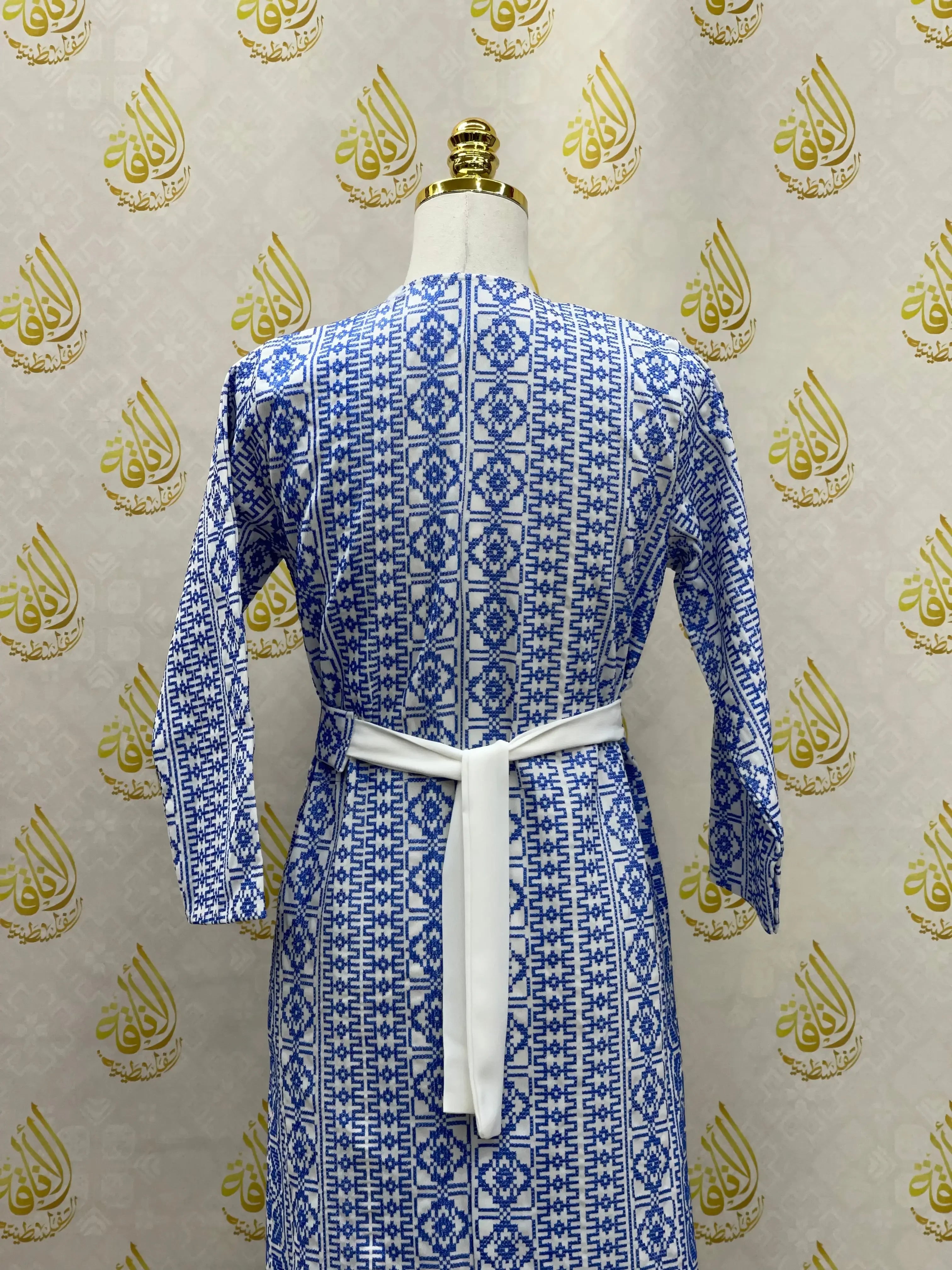 Palestinian Elegance embroidered cardigan for kids with blue geometric patterns and white belt