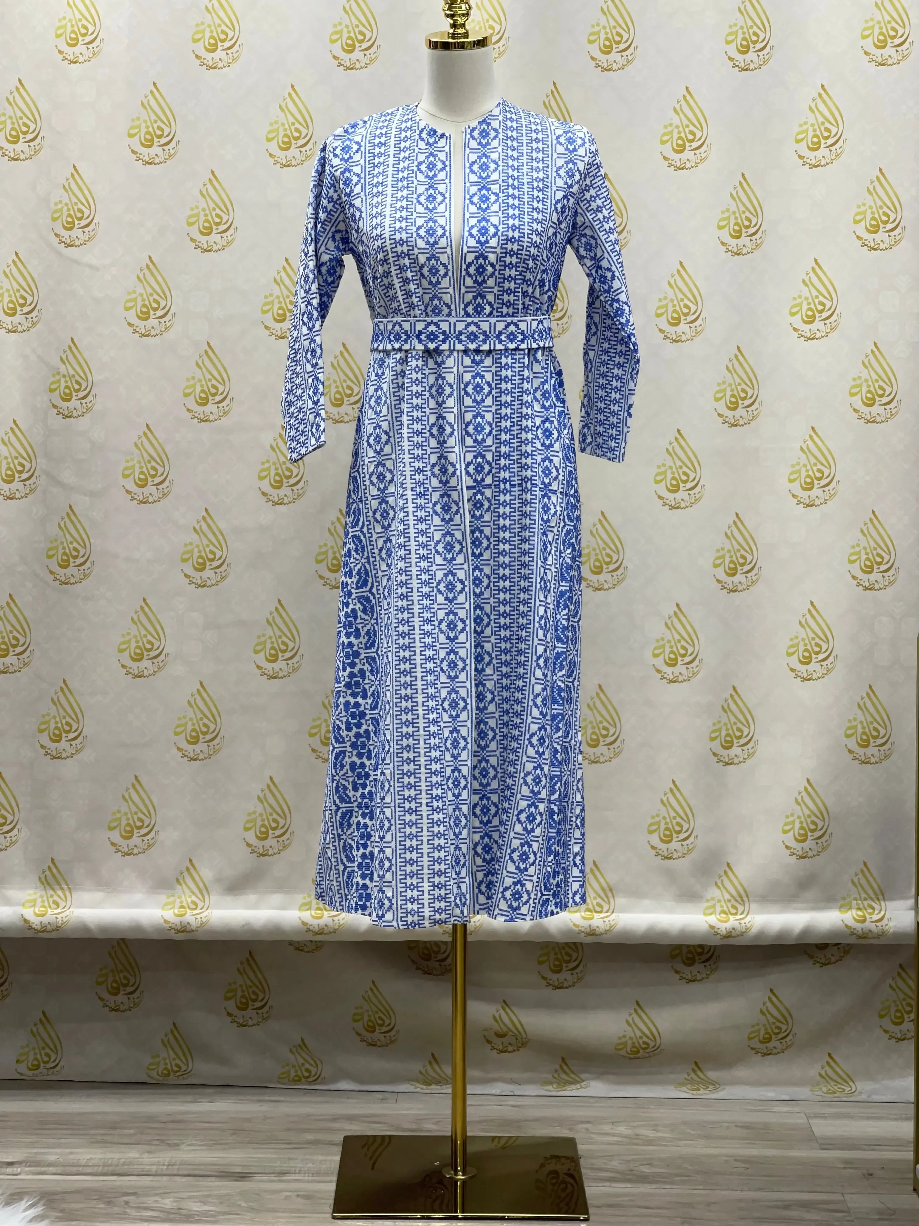 Palestinian Elegance blue embroidered cardigan for kids with long sleeves and intricate patterns on mannequin