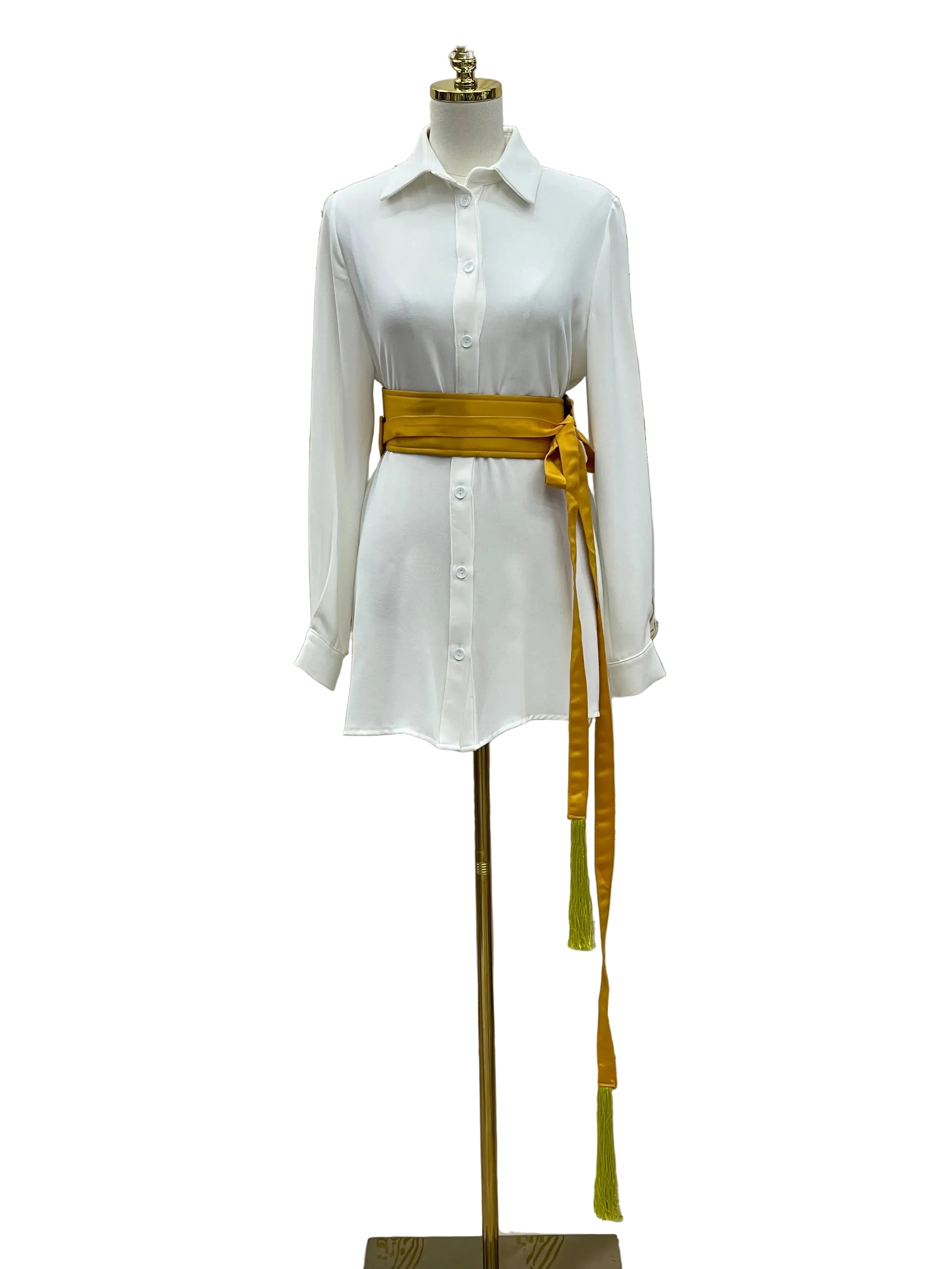 Luxury satin belt for dresses in golden yellow paired with white button-up shirt dress on mannequin