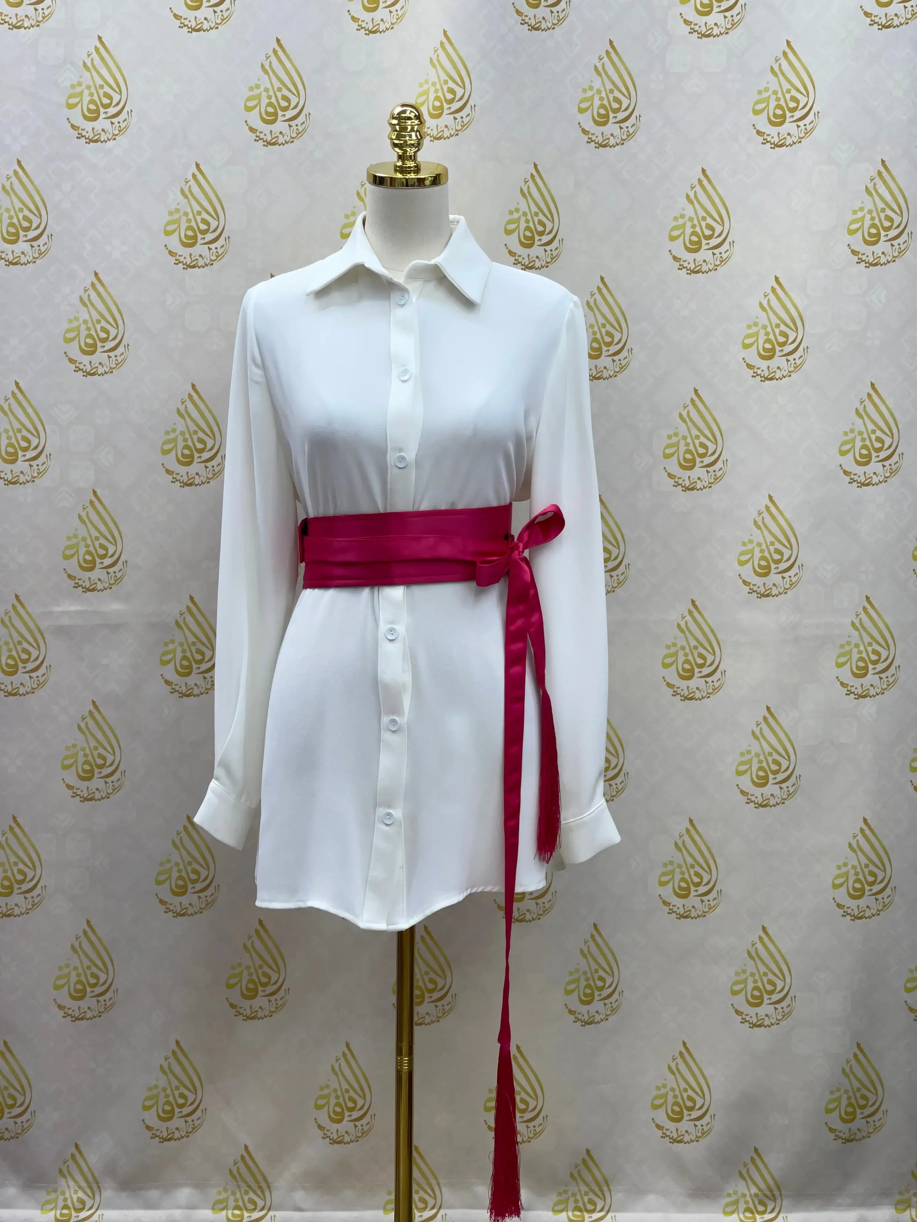 Luxury satin belt for dresses in vibrant pink styled on white button-down dress from Palestinian Elegance