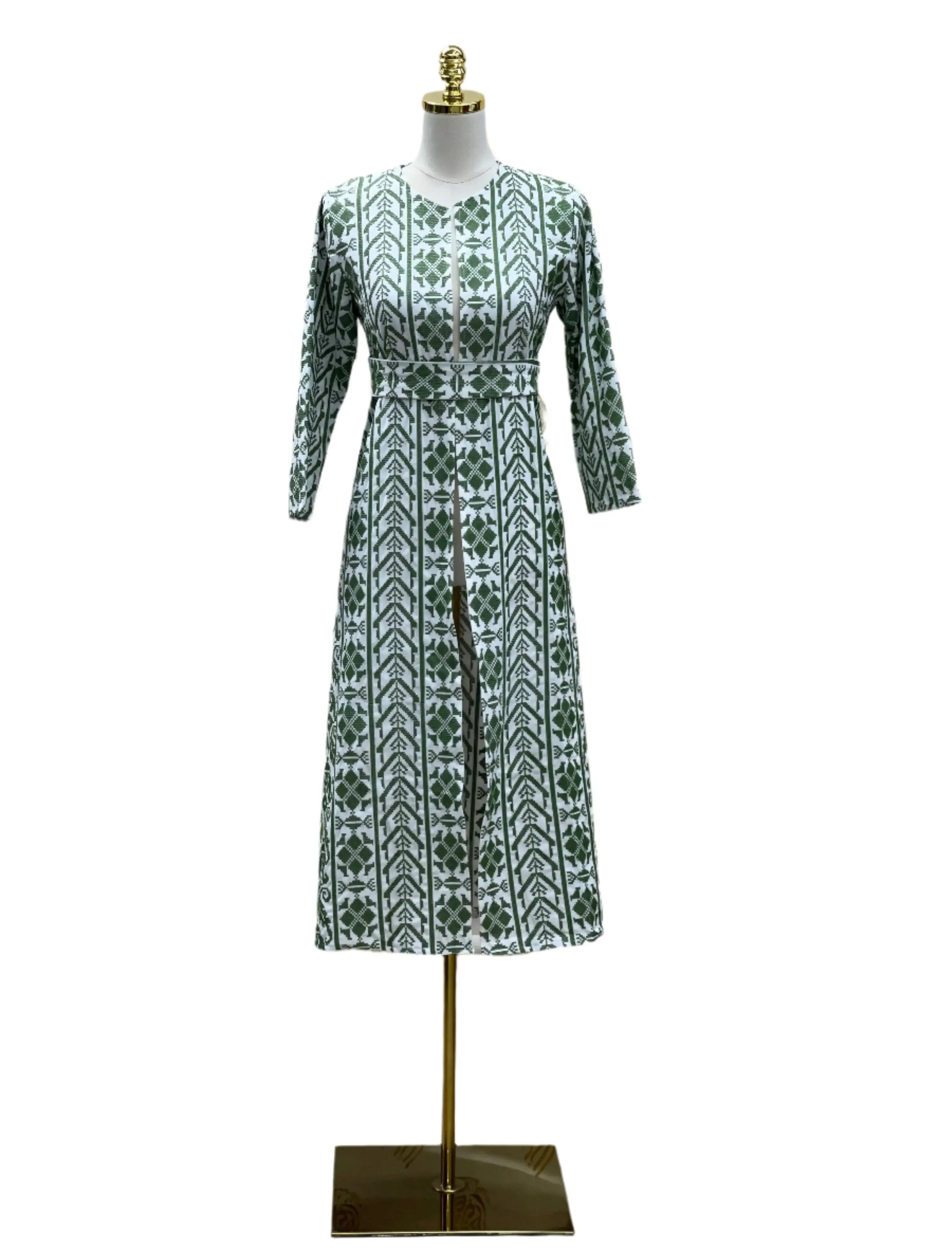 Palestinian Elegance embroidered cardigan for kids with green geometric patterns on white fabric