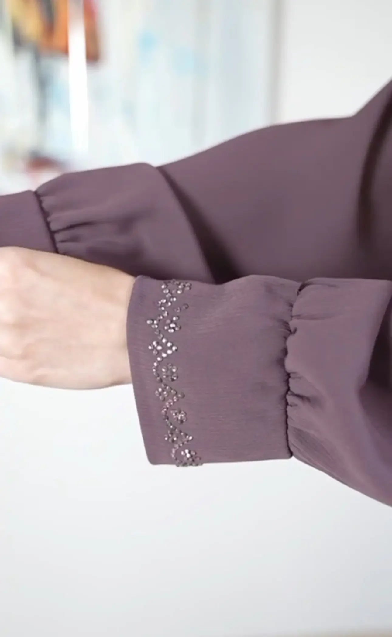 Close-up of purple sleeve with bead embellishments on a modest abaya for women by Palestinian Elegance