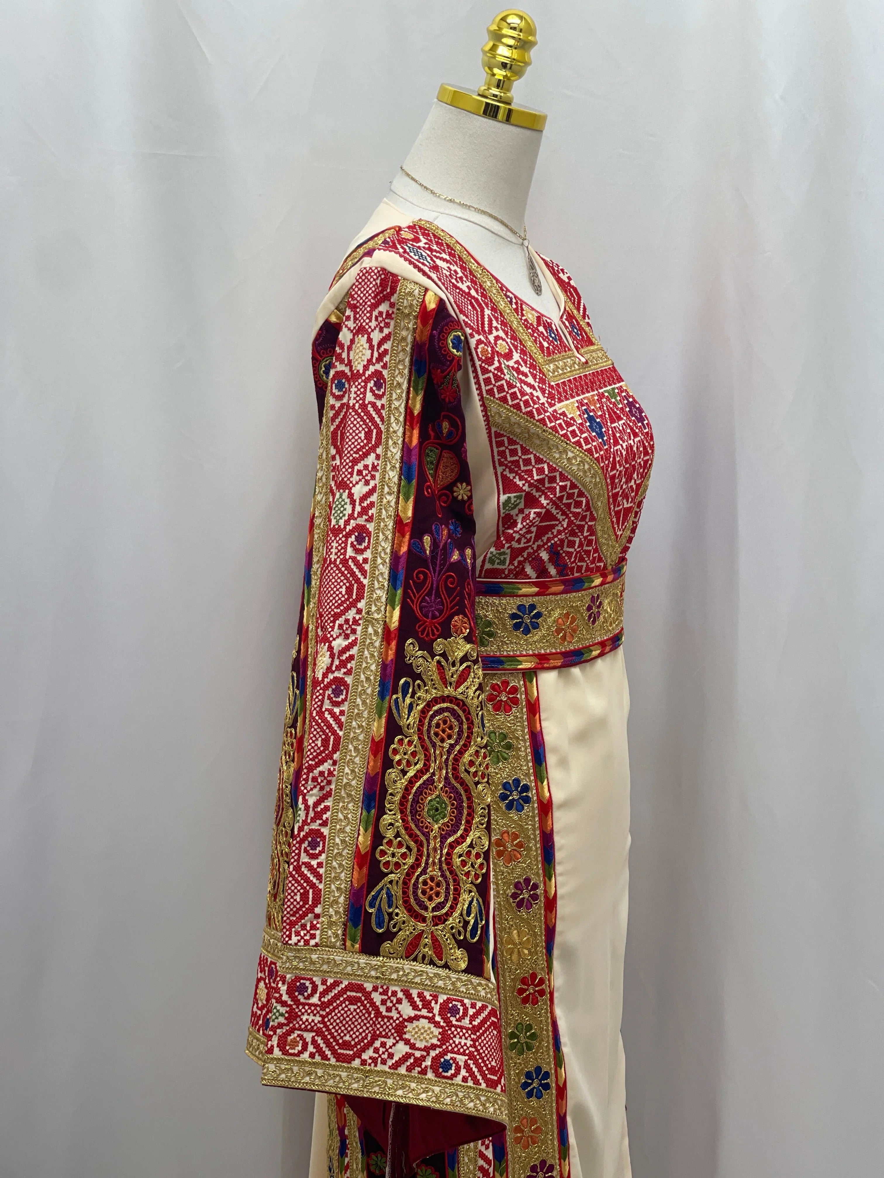 Al Kananiyyah Embroidered Thobe featuring intricate patterns and vibrant colors on sleeves and bodice