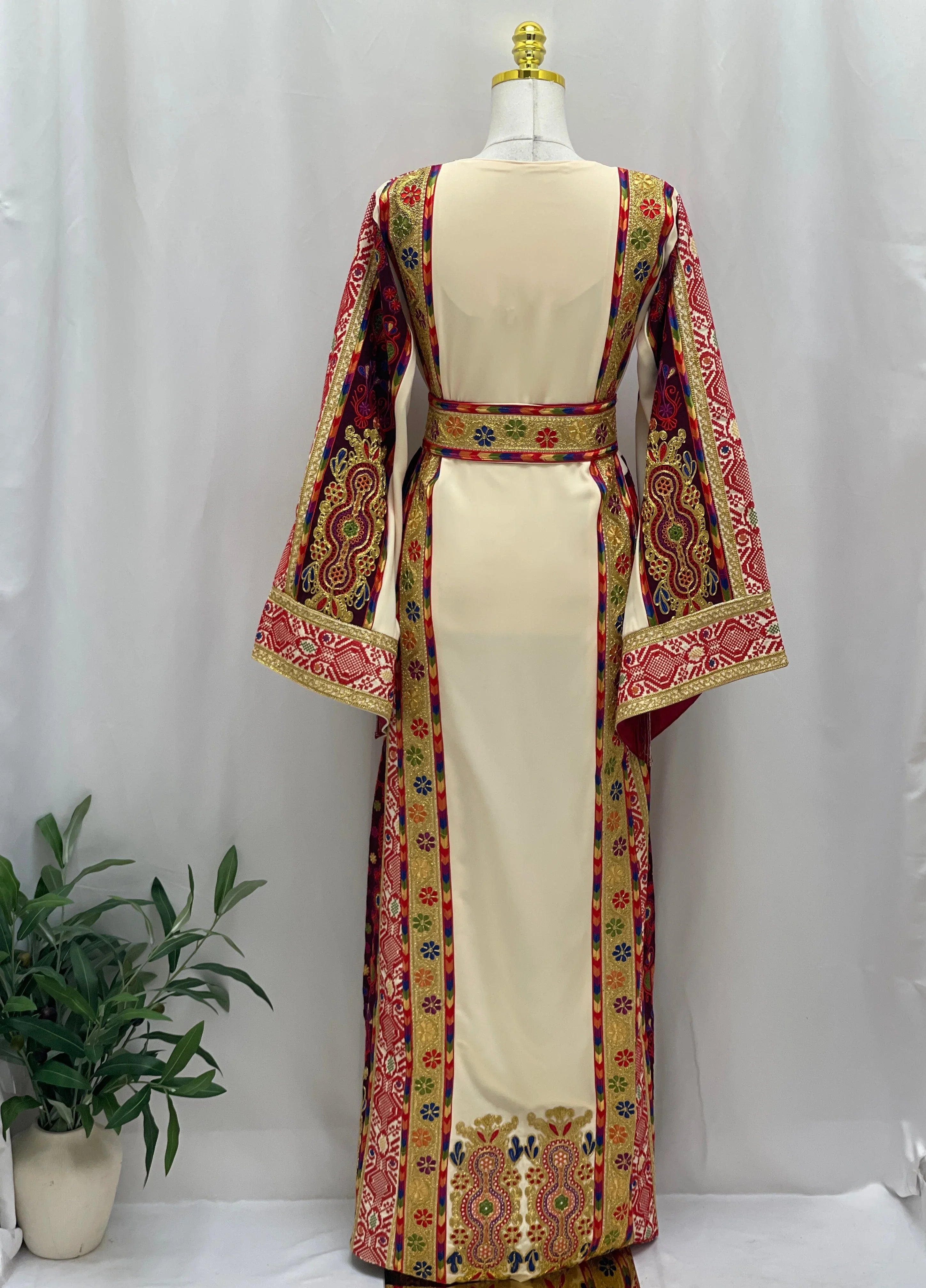 Back view of Al Kananiyyah Embroidered Thobe featuring vibrant patterns and flowing sleeves