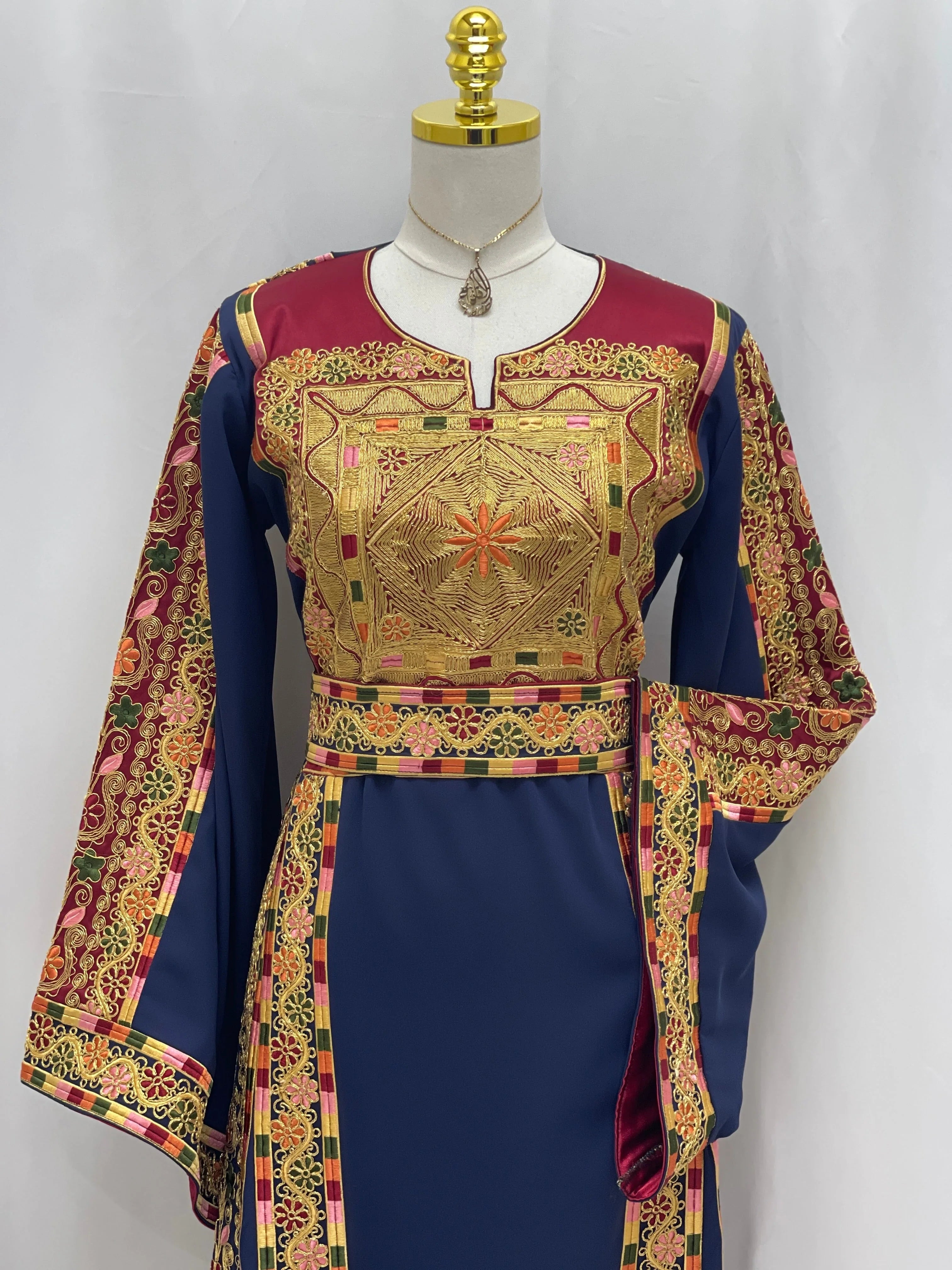 Al-Qasab Malaki Thobe by Palestinian Elegance featuring intricate gold embroidery and vibrant colors
