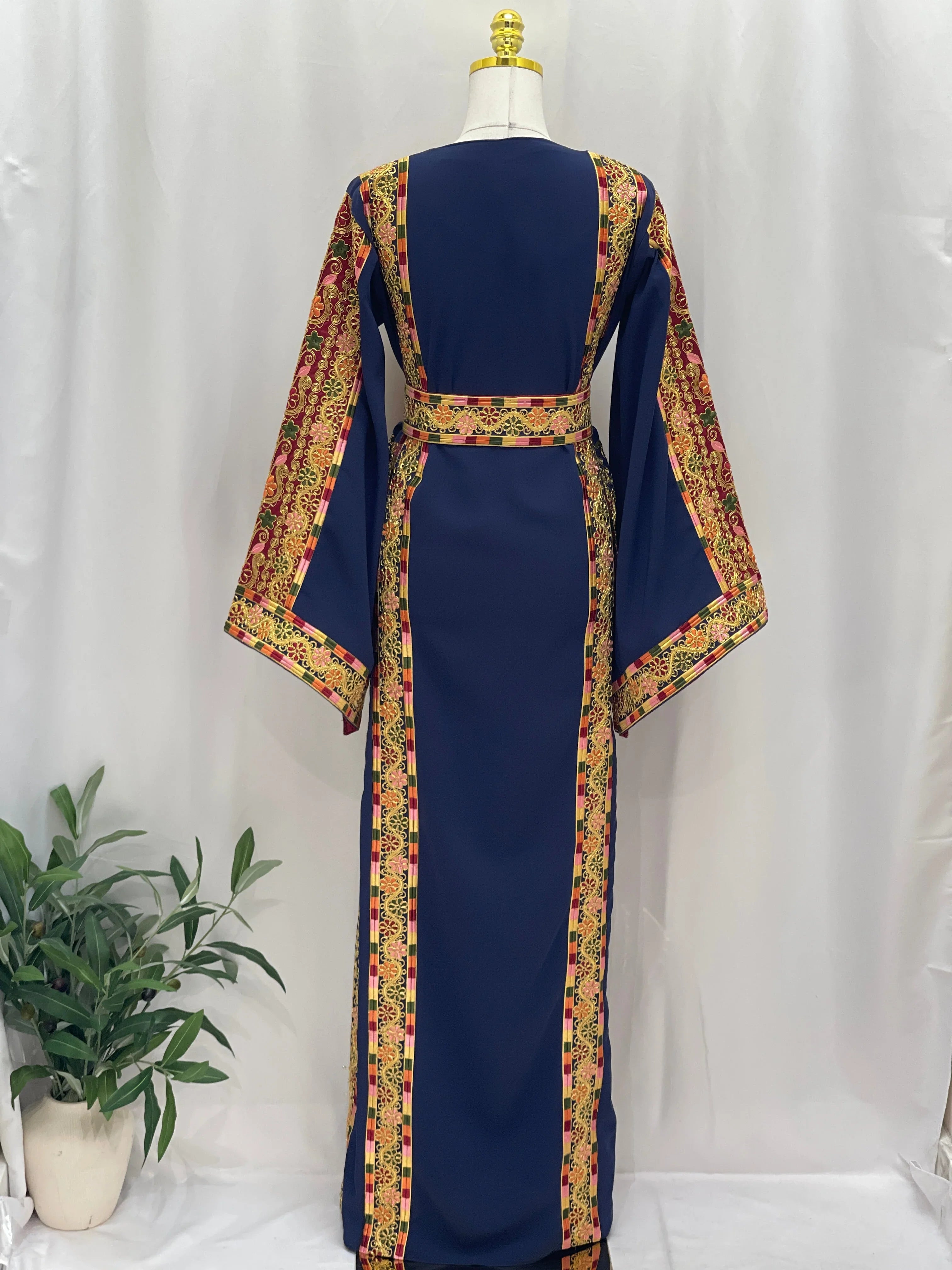 Elegant back view of the Al-Qasab Malaki Thobe featuring intricate embroidery and flowing sleeves