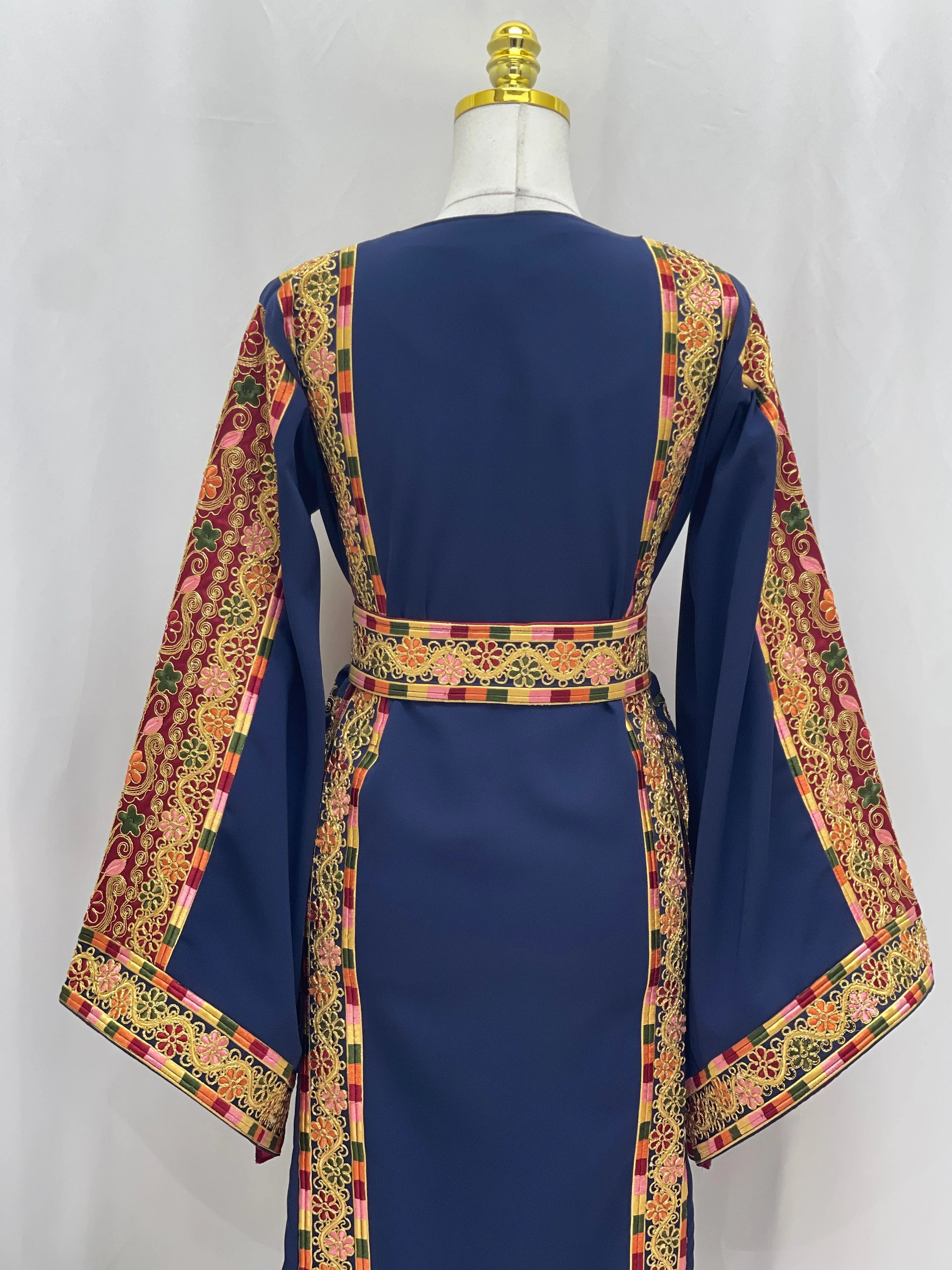 Back view of Al-Qasab Malaki Thobe with vibrant embroidered patterns and elegant sleeves