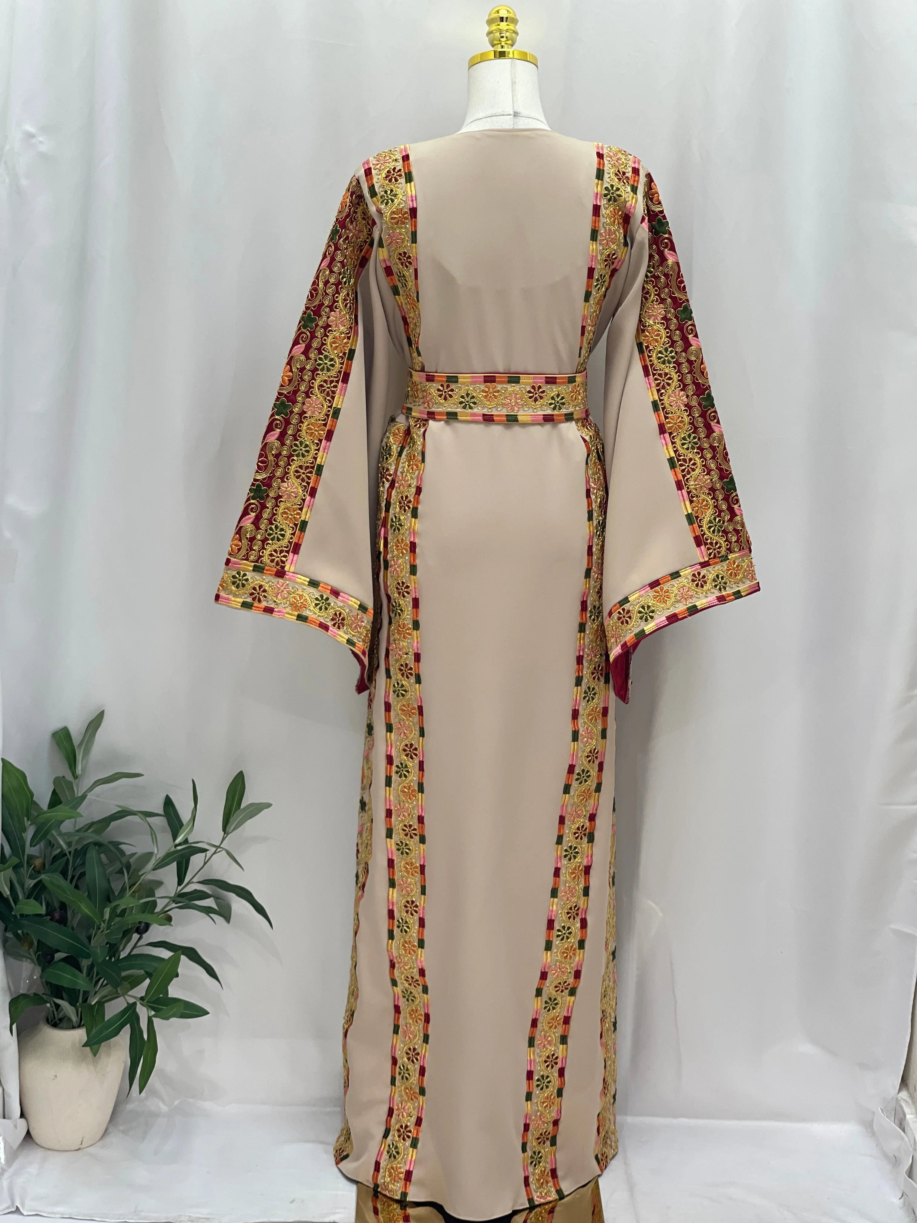 Back view of a beige Embroidered Al-Qasab Malaki Thobe with colorful floral trims and flowy sleeves