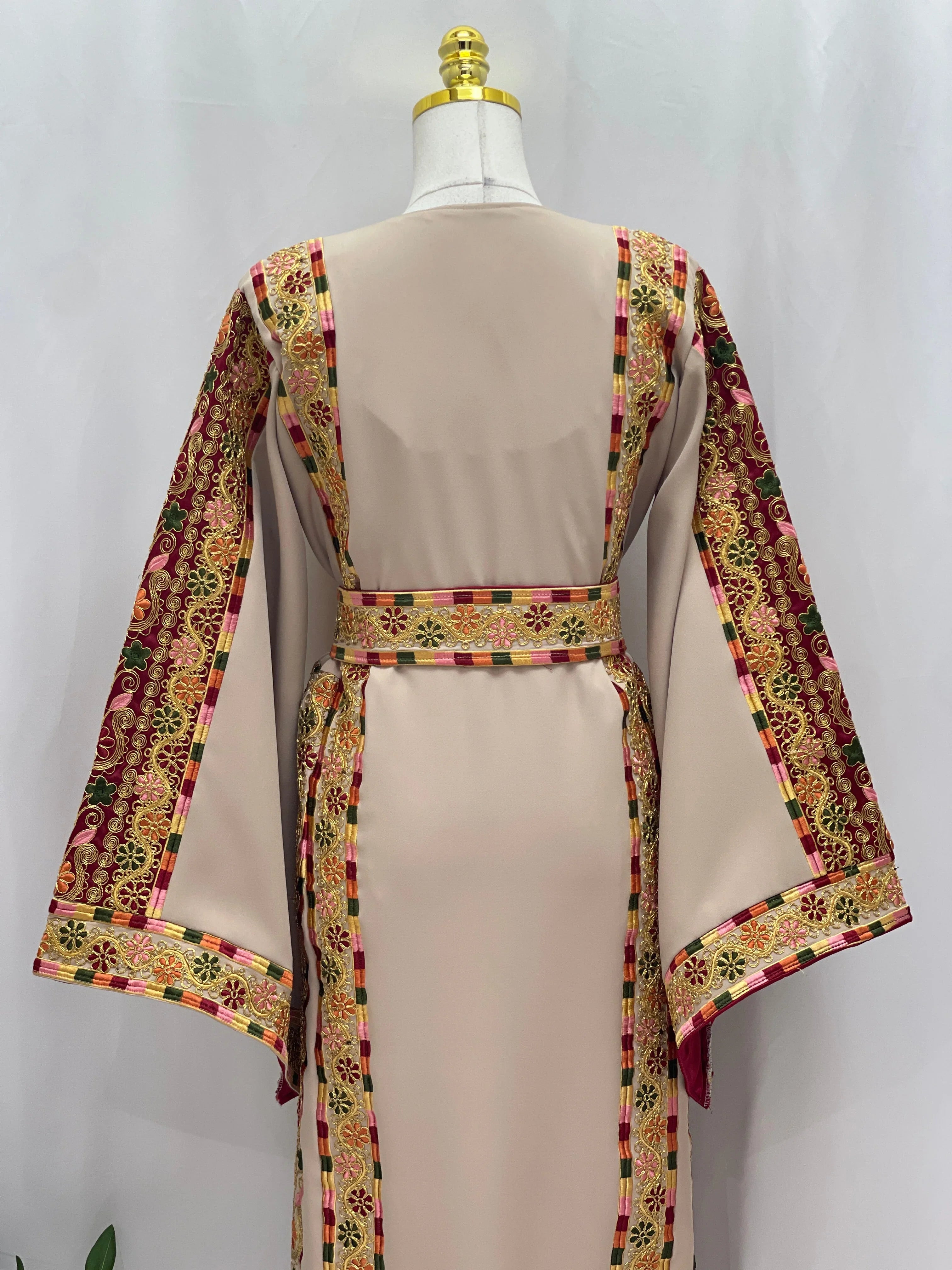 Back view of the Al-Qasab Malaki Thobe featuring colorful embroidered patterns on the sleeves and waist