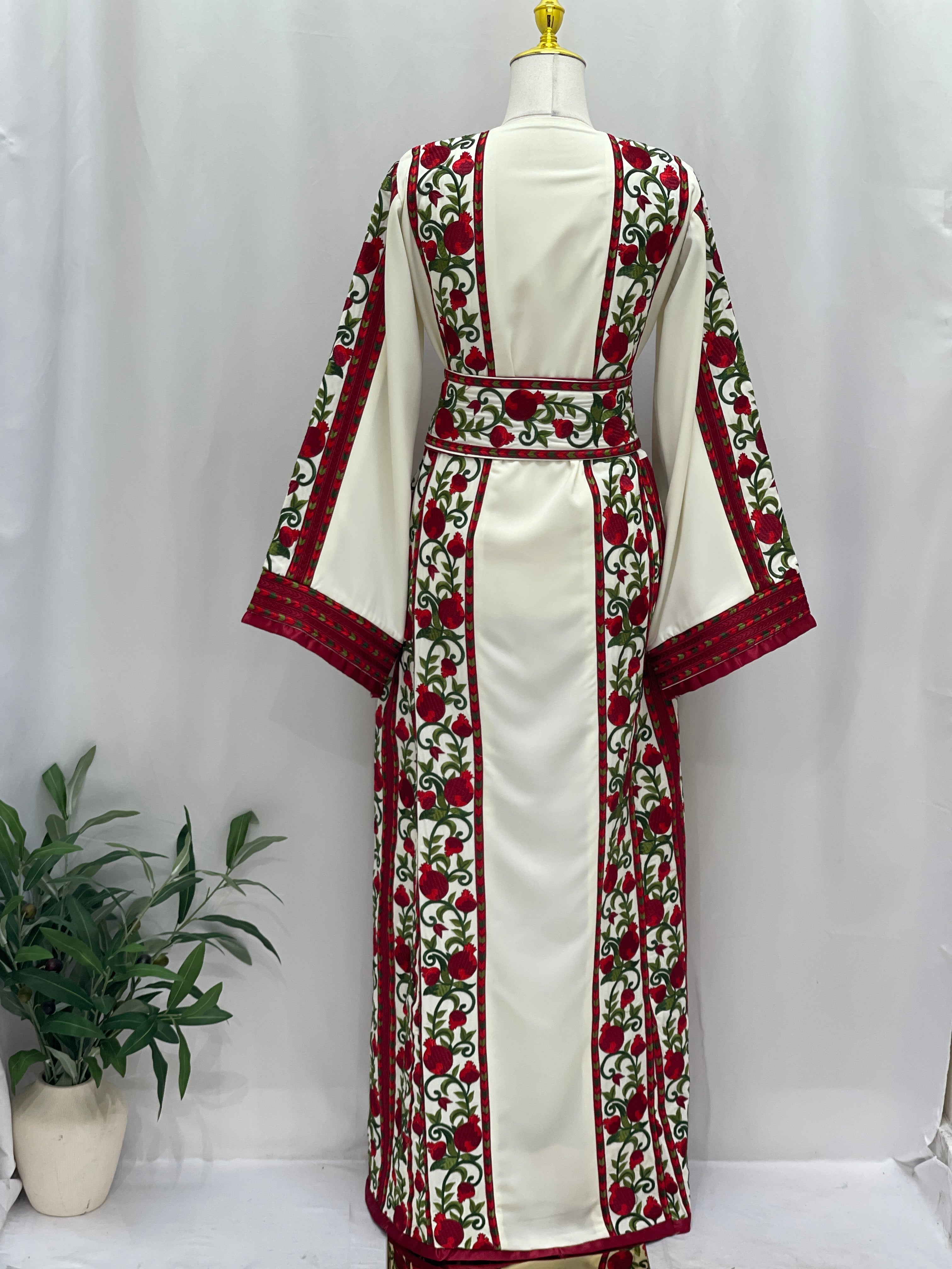 Al Romana Pomegranate Embroidered Thoub by Palestinian Elegance in white with red and green floral embroidery