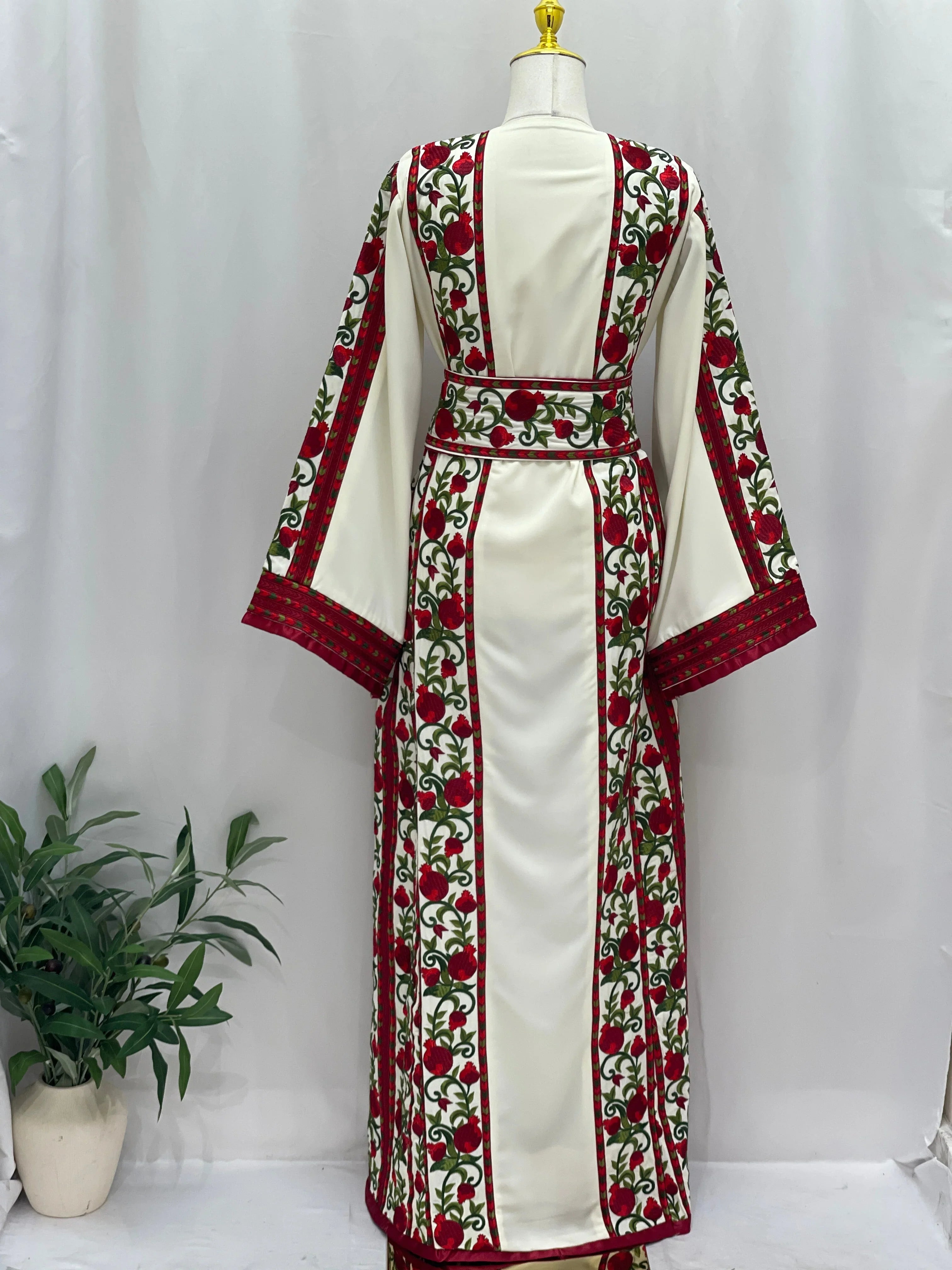 Al Romana Pomegranate Embroidered Thoub by Palestinian Elegance in white with red and green floral embroidery